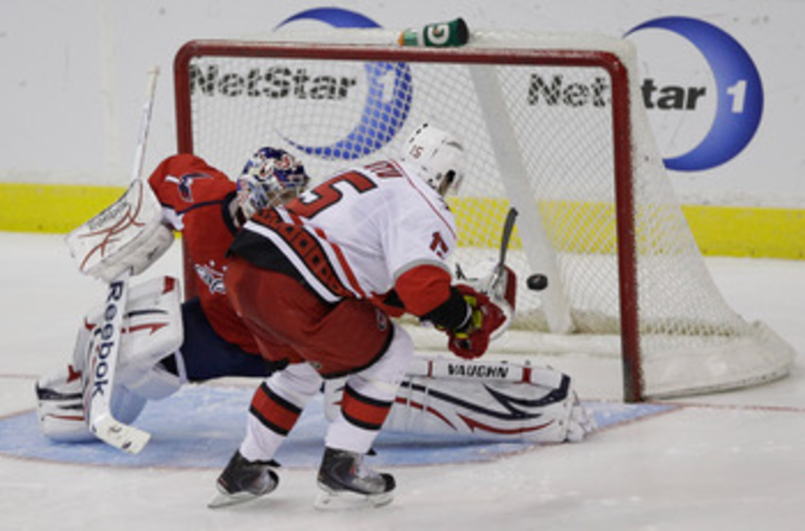 WASHINGTON, DC - MARCH 29:  Tuomo Ruutu #15 of the Carolina Hurricanes scores the game clinching goal on goalie Semyon Varlamov #1 of the Washington Capitals during a shootout at the Verizon Center on March 29, 2011 in Washington, DC. (Photo by Rob Carr/G