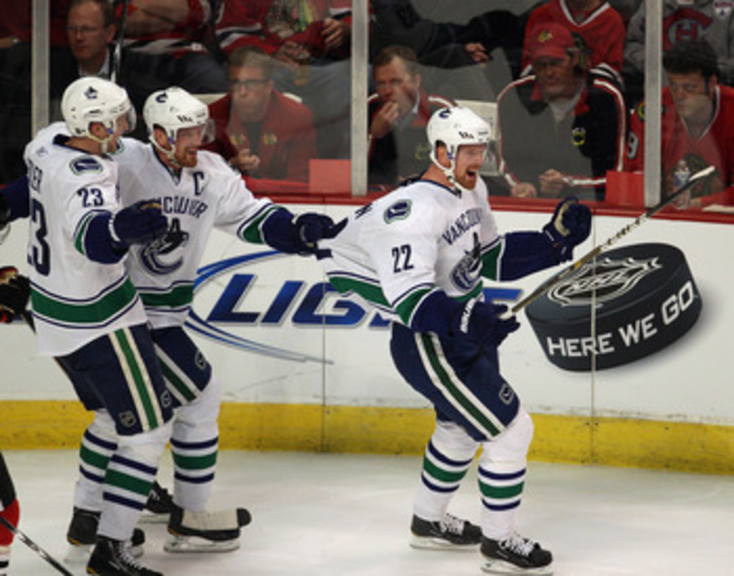 CHICAGO, IL - APRIL 17: Daniel Sedin #22 of the Vancouver Canucks is grabbed by the jersey by his brother Henrik Sedin #33 after scoring a goal in the 2nd period against the Chicago Blackhawks while teammate Alexander Edler #23 joins the celebration in Ga