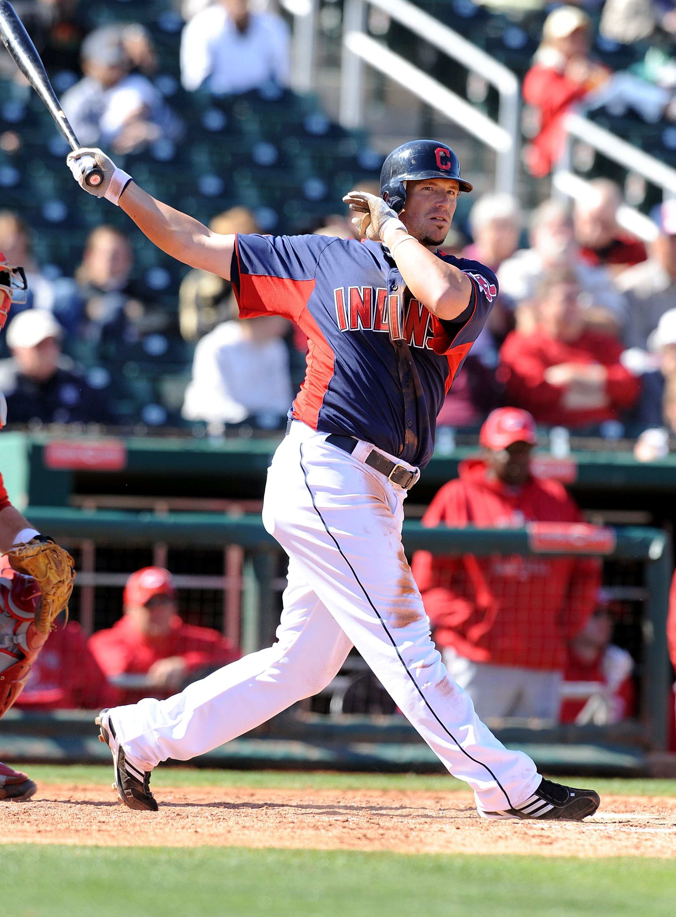 GOODYEAR, AZ - FEBRUARY 27:  Travis Buck #28 of the Cleveland Indians watches the ball after hitting it down the first base line against the Cincinnati Reds at Goodyear Ballpark on February 27, 2011 in Goodyear, Arizona.  (Photo by Norm Hall/Getty Images)