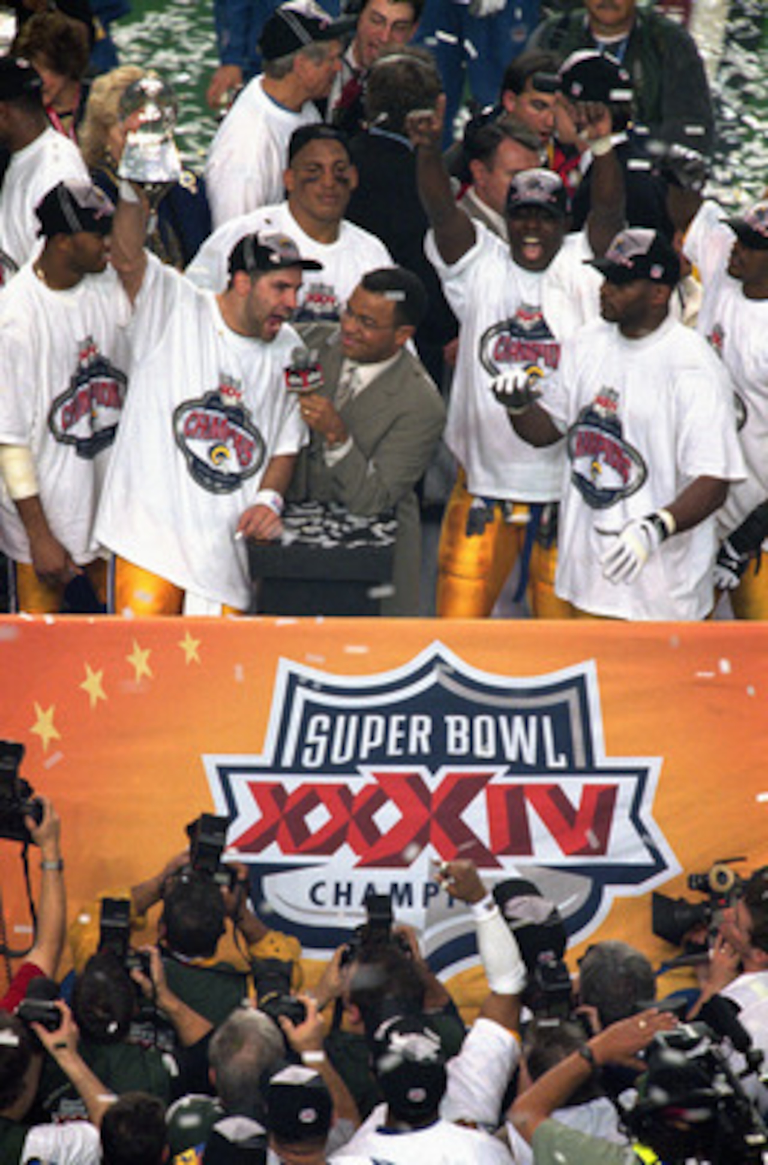 ATLANTA - JANUARY 30:  Quarterback Kurt Warner #13 of the St. Louis Rams celebrates as he hoist up the Lombardi trophy after defeating the Tennessee Titans 23-16 in Super Bowl XXXIV at the Georgia Dome on January 30, 2000 in Atlanta, Georgia.  (Photo by B