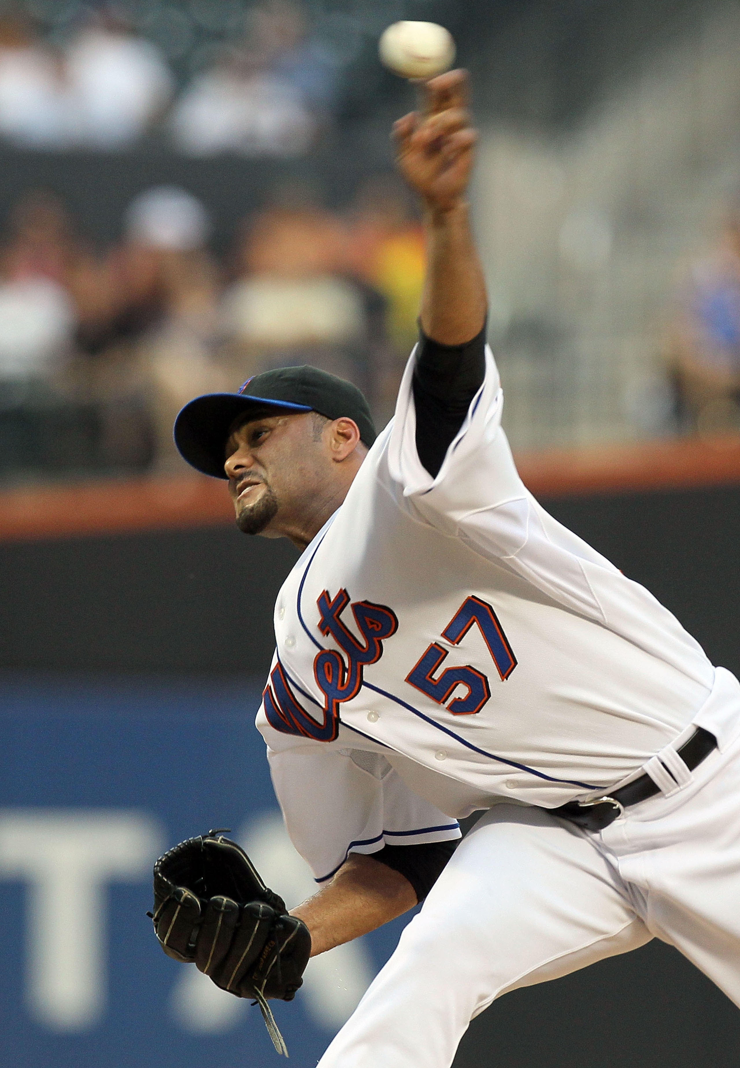 NEW YORK - JULY 06:  Johan Santana #57 of the New York Mets delivers a pitch against the Cincinnati Reds on July 6, 2010 at Citi Field in the Flushing neighborhood of the Queens borough of New York City.  (Photo by Jim McIsaac/Getty Images)