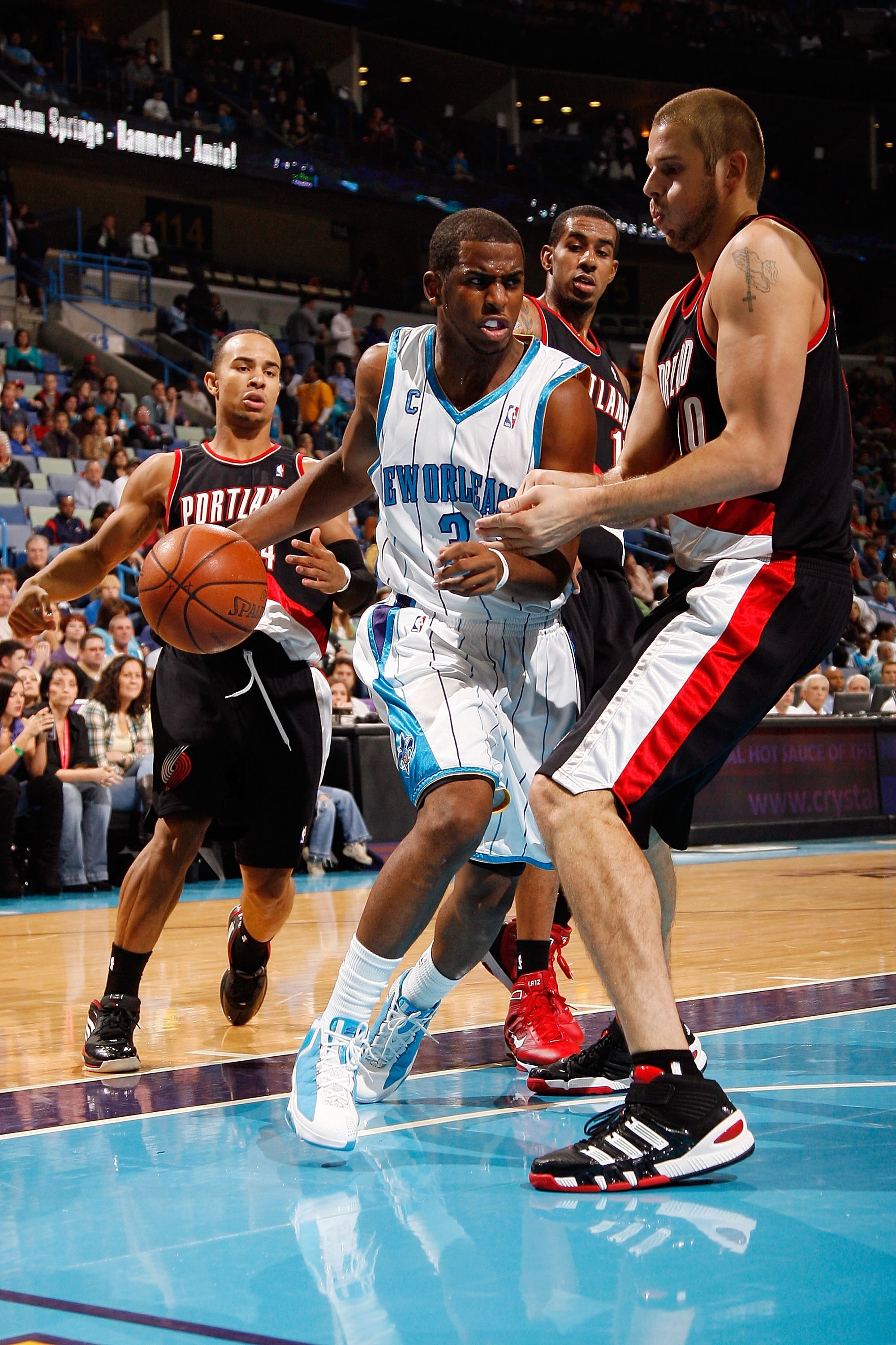 NEW ORLEANS - NOVEMBER 13:  Chris Paul #3 of the New Orleans Hornets drives the ball around Joel Przybilla #10 of the Portland Trail Blazers at the New Orleans Arena on November 13, 2009 in New Orleans, Louisiana.  NOTE TO USER: User expressly acknowledge