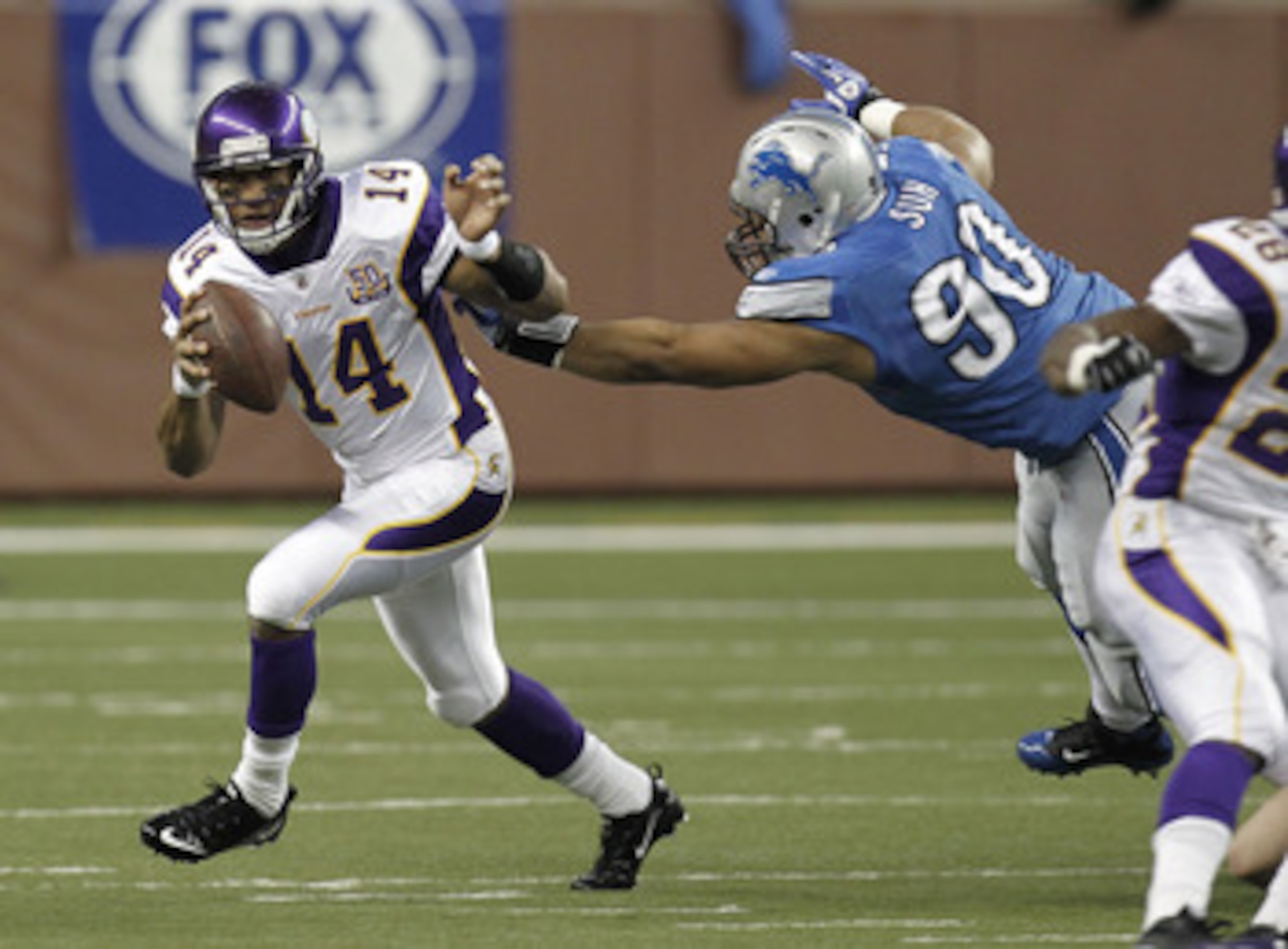 DETROIT, MI - JANUARY 02:  Joe Webb #14 of the Minnesota Vikings runs around the tackle of Ndamukong Suh #90 of the Detroit Lions at Ford Field on January 2, 2011 in Detroit, Michigan.  (Photo by Gregory Shamus/Getty Images)
