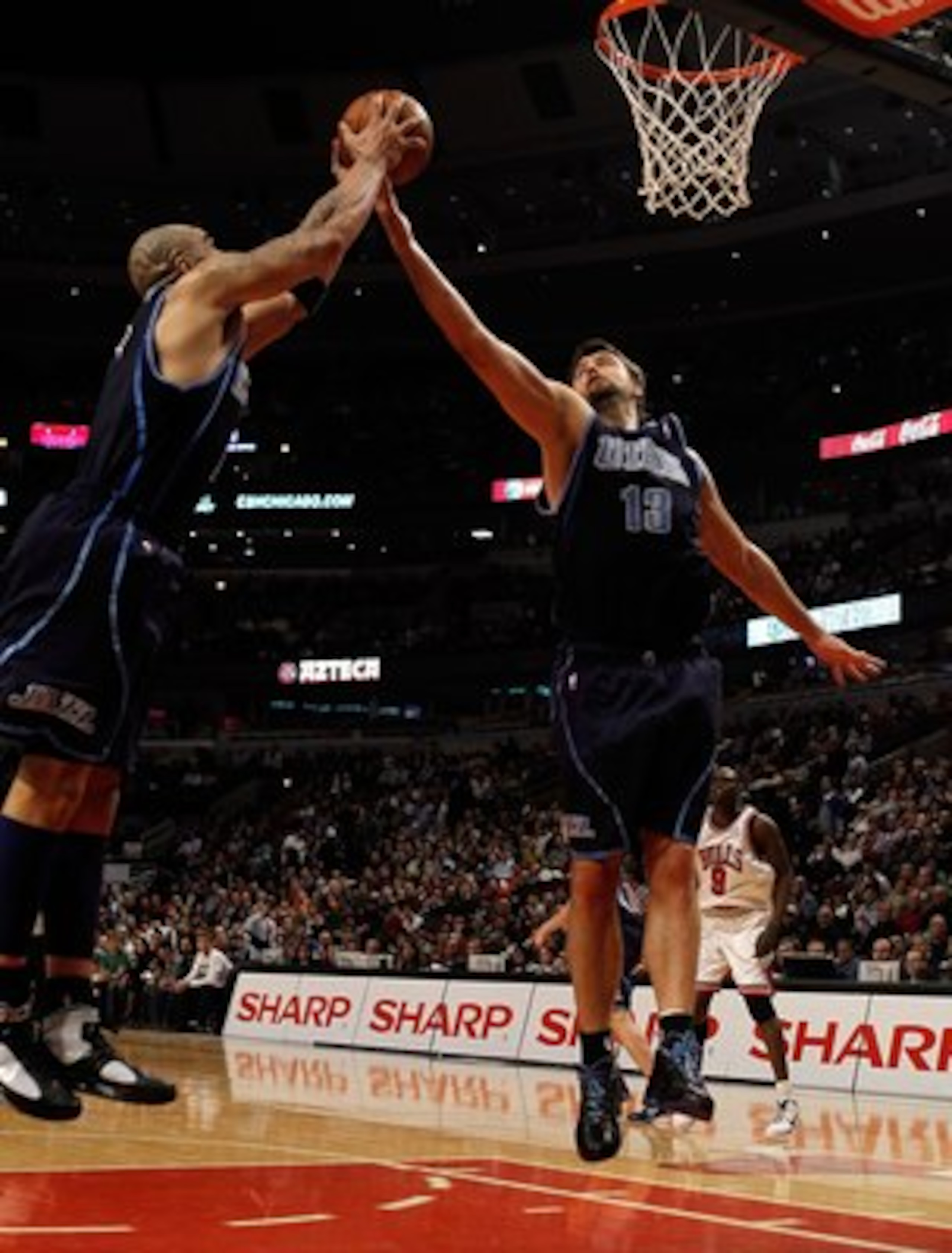 CHICAGO - MARCH 09: Carlos Boozer #5 and Mehmet Okur #13 of the Utah Jazz leap for a rebound against the Chicago Bulls at the United Center on March 9, 2010 in Chicago, Illinois. The Jazz defeated the Bulls 132-108. NOTE TO USER: User expressly acknowledg CHICAGO - MARCH 09: Carlos Boozer #5 and Mehmet Okur #13 of the Utah Jazz leap for a rebound against the Chicago Bulls at the United Center on March 9, 2010 in Chicago, Illinois. The Jazz defeated the Bulls 132-108. NOTE TO USER: User expressly acknowledg
