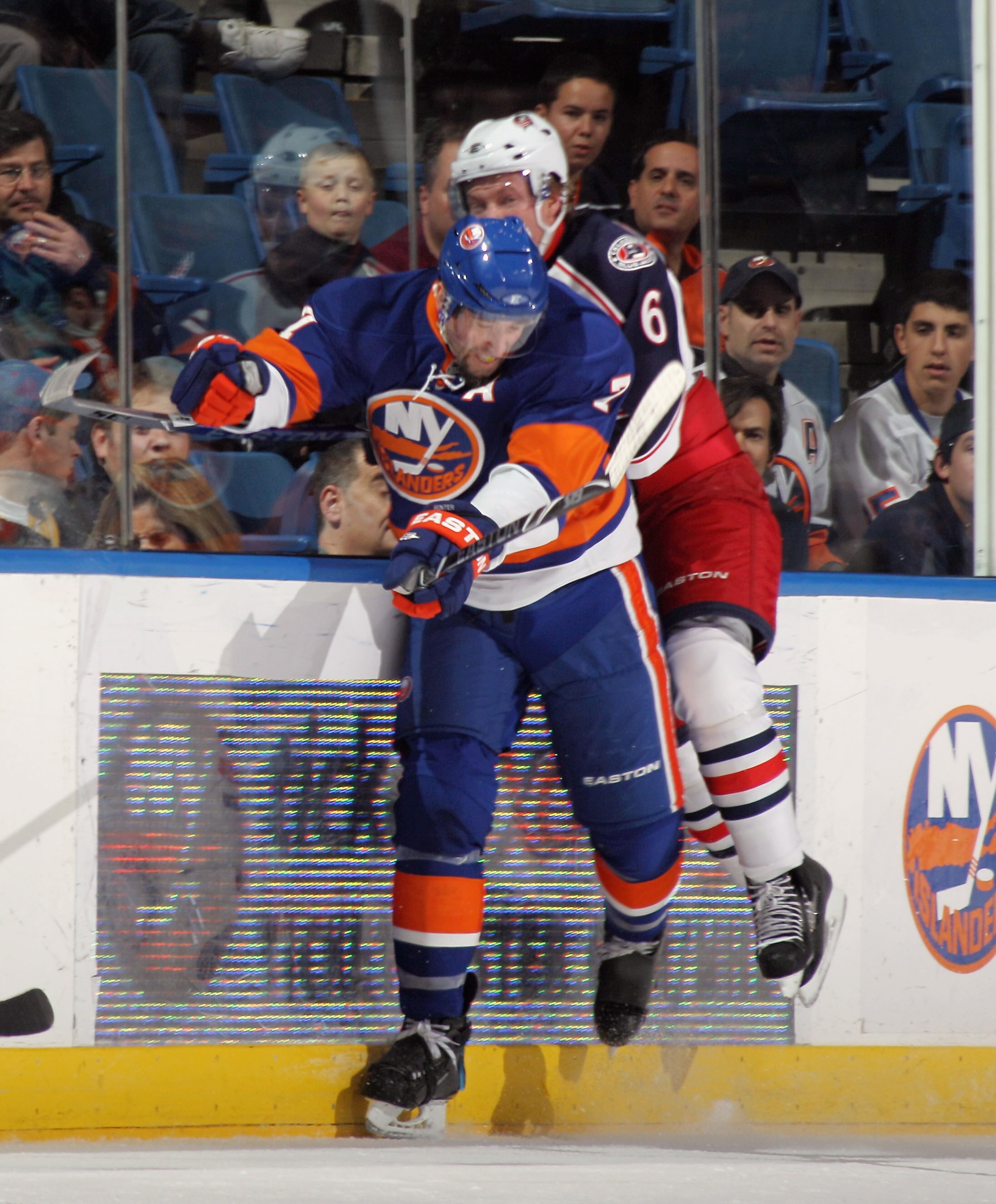 UNIONDALE, NY - NOVEMBER 24:  Anton Stralman #6 of the Columbus Blue Jackets is hit by Trent Hunter #7 of the New York Islanders at the Nassau Coliseum on November 24, 2010 in Uniondale, New York. Hunter left the ice following the hit with a leg injury. T