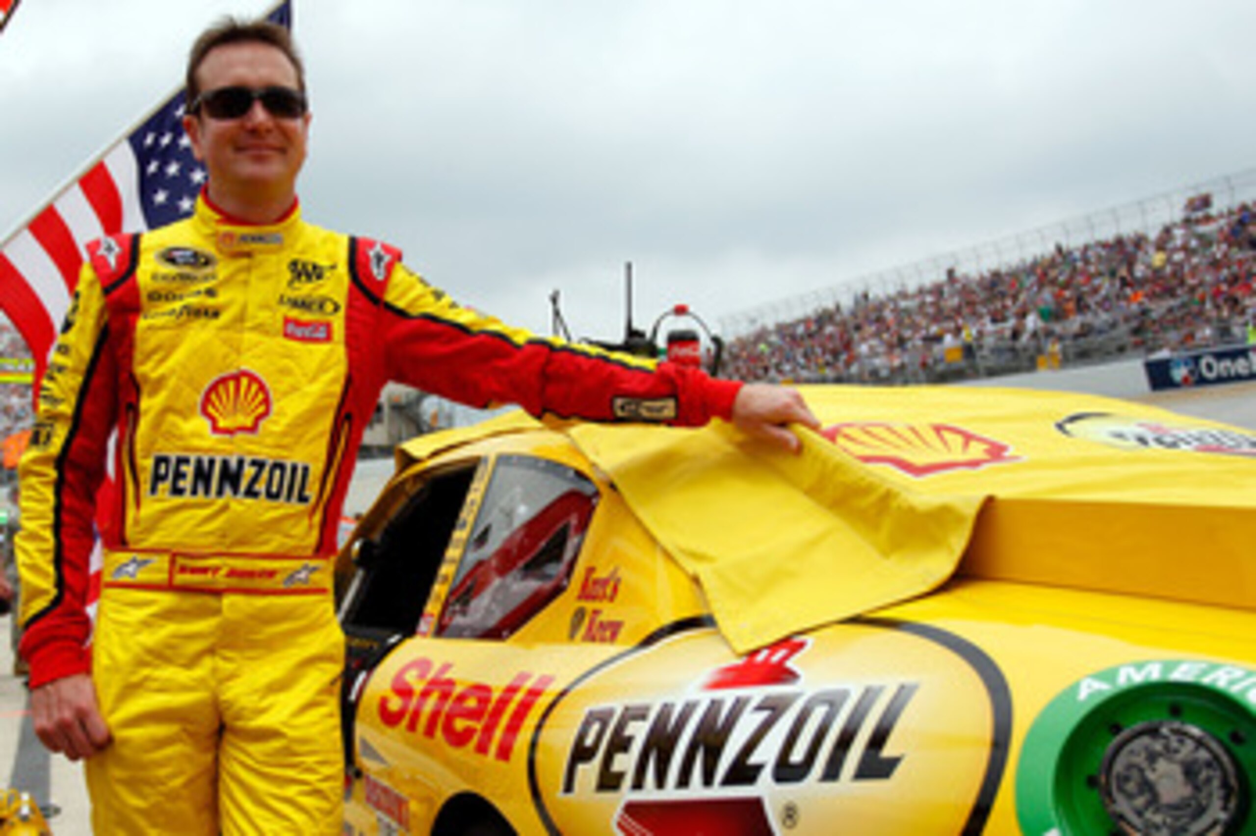 DOVER, DE - MAY 15: Kurt Busch, driver of the #22 Shell/Pennzoil Dodge, stands next to his car on the grid prior the NASCAR Sprint Cup Series FedEx 400 Benefiting Autism Speaks at Dover International Speedway on May 15, 2011 in Dover, Delaware. (Photo b DOVER, DE - MAY 15: Kurt Busch, driver of the #22 Shell/Pennzoil Dodge, stands next to his car on the grid prior the NASCAR Sprint Cup Series FedEx 400 Benefiting Autism Speaks at Dover International Speedway on May 15, 2011 in Dover, Delaware. (Photo b