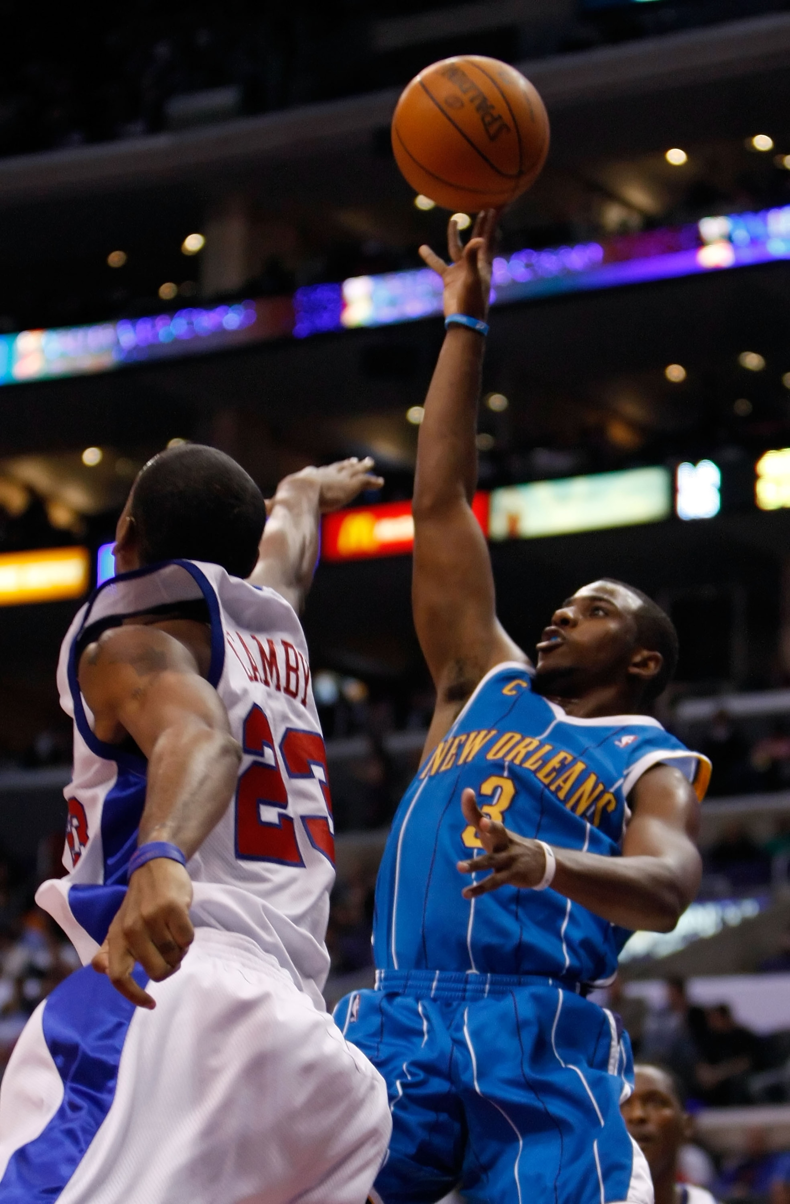 LOS ANGELES, CA - NOVEMBER 09:  Chris Paul #3 of the New Orleans Hornets shoots over Marcus Camby #23 of the Los Angeles Clippers in the first half at Staples Center on November 9, 2009 in Los Angeles, California. NOTE TO USER: User expressly acknowledges