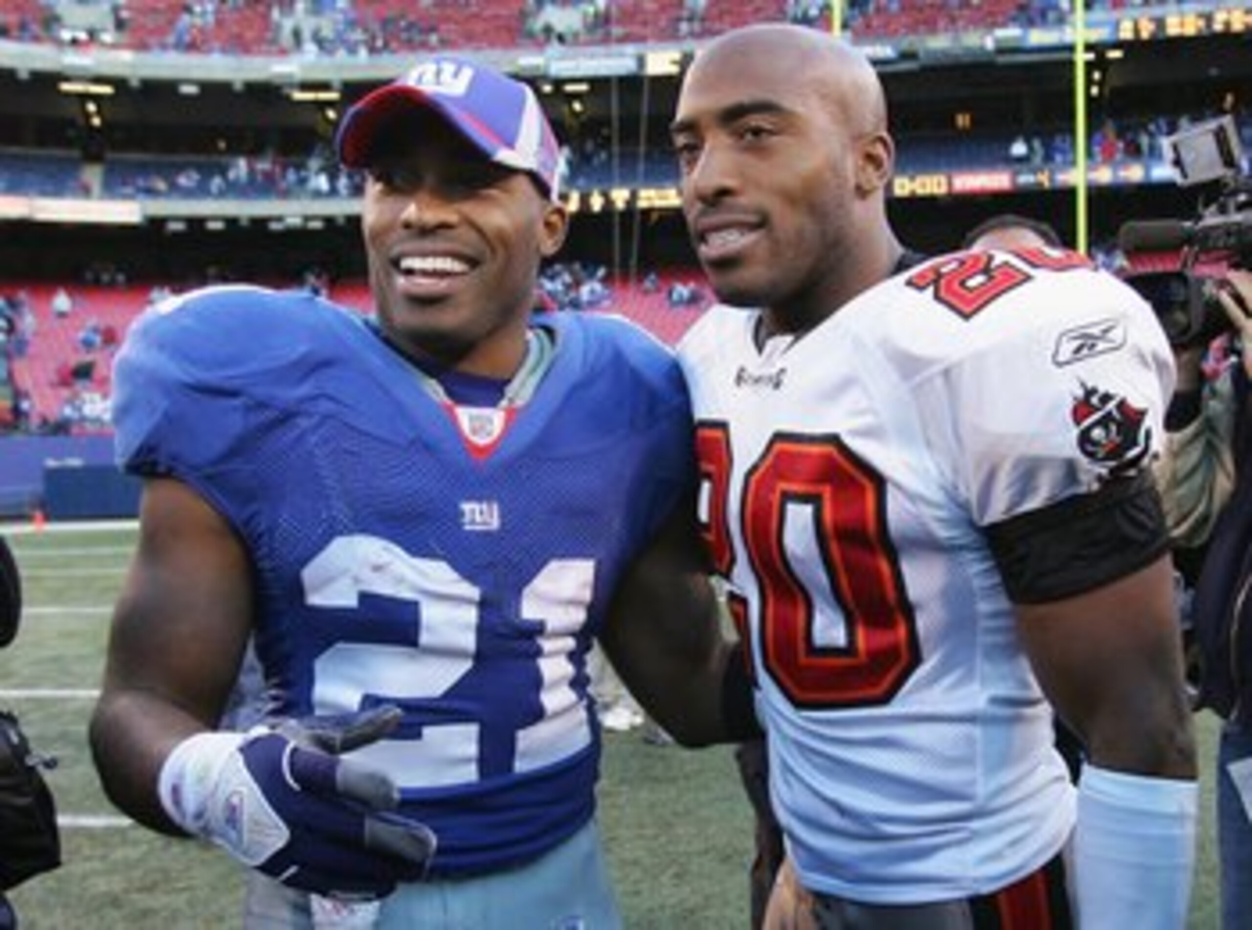 EAST RUTHERFORD, NJ - OCTOBER 29: Tiki Barber #21 of the New York Giants (L) greets his brother Ronde Barber #20 of the Tampa Bay Buccaneers after the game on October 29, 2006 at Giants Stadium in East Rutherford, New Jersey. The Giants defeated the Bucs