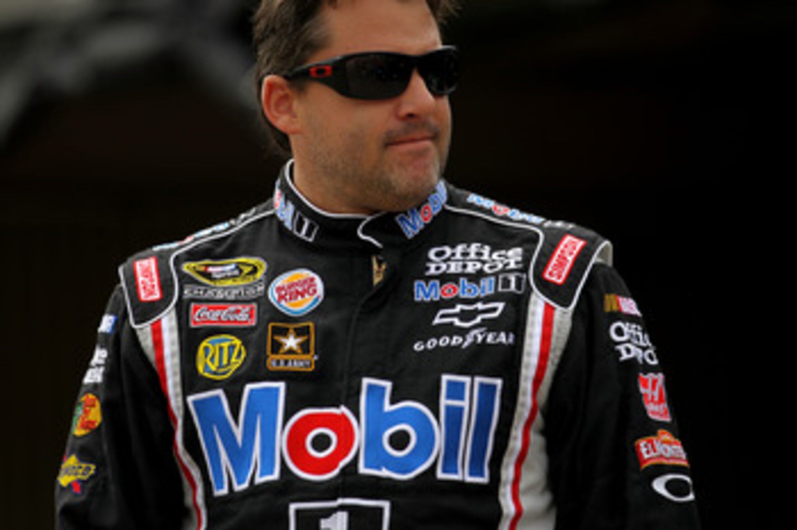 DOVER, DE - MAY 13: Tony Stewart, driver of the #14 Mobil 1/Office Depot Chevrolet, walks in the garage area during practice for the NASCAR Sprint Cup Series FedEx 400 Benefiting Autism Speaks at Dover International Speedway on May 13, 2011 in Dover, Del DOVER, DE - MAY 13: Tony Stewart, driver of the #14 Mobil 1/Office Depot Chevrolet, walks in the garage area during practice for the NASCAR Sprint Cup Series FedEx 400 Benefiting Autism Speaks at Dover International Speedway on May 13, 2011 in Dover, Del