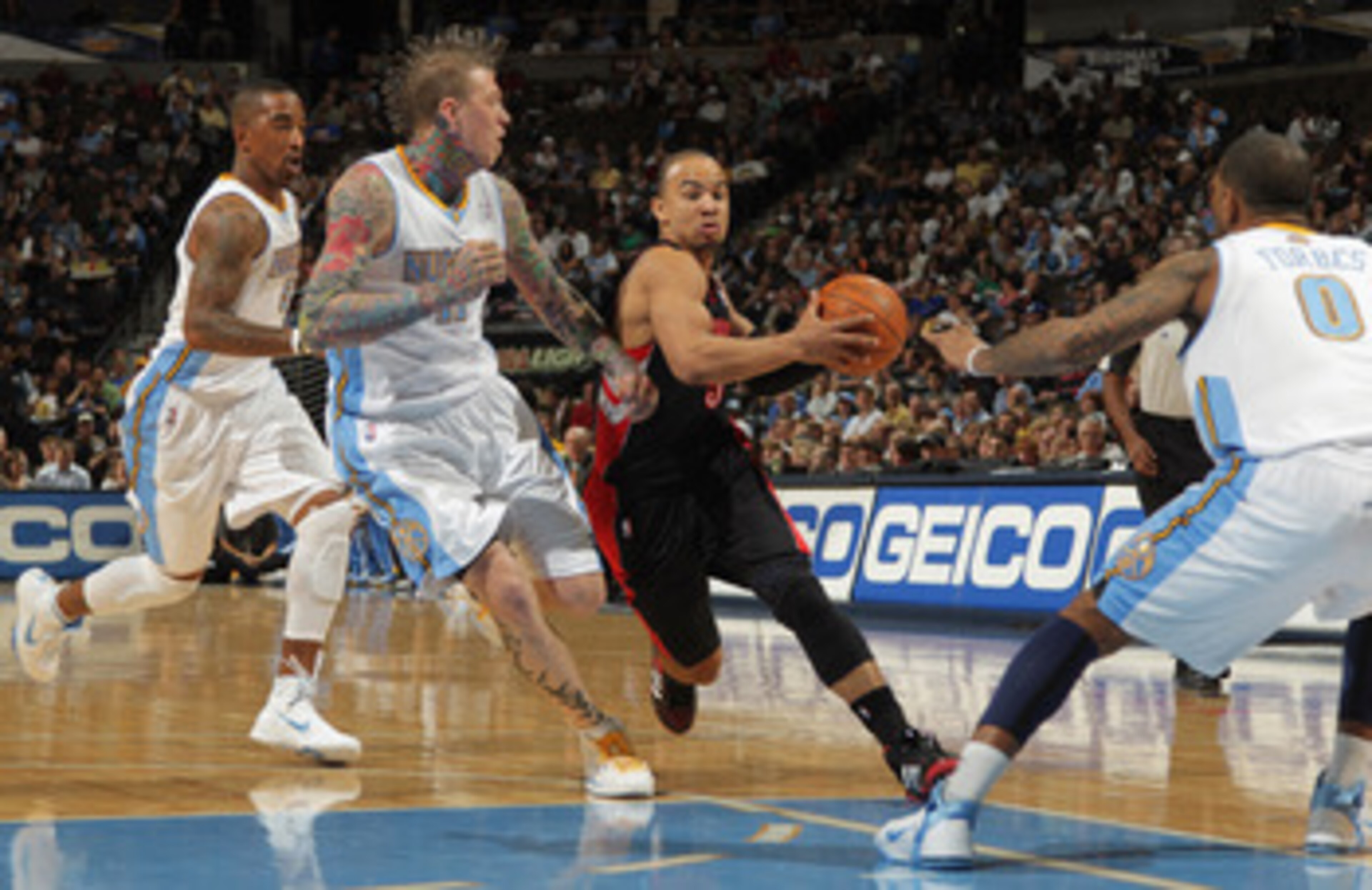 DENVER, CO - MARCH 21: Jerryd Bayless #5 of the Toronto Raptors controls the ball against J.R. Smith #5, Chris Andersen #11 and Gary Forbes #0 of the Denver Nuggets at the Pepsi Center on March 21, 2011 in Denver, Colorado. The Nuggets defeated the Rapto DENVER, CO - MARCH 21: Jerryd Bayless #5 of the Toronto Raptors controls the ball against J.R. Smith #5, Chris Andersen #11 and Gary Forbes #0 of the Denver Nuggets at the Pepsi Center on March 21, 2011 in Denver, Colorado. The Nuggets defeated the Rapto