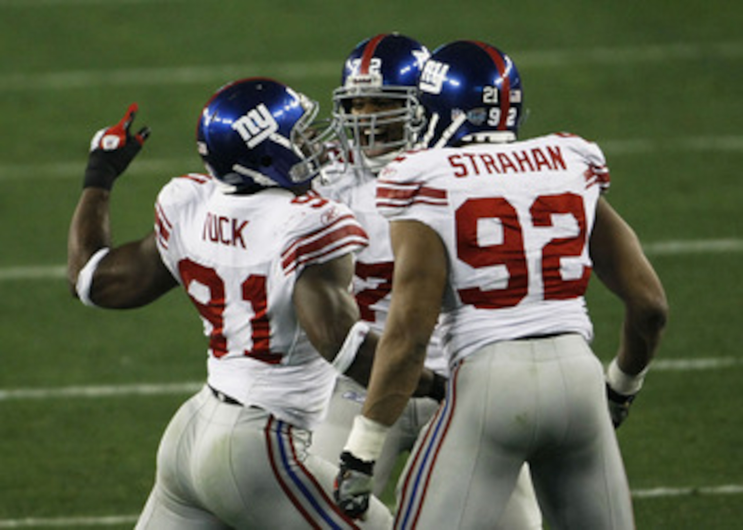 GLENDALE, AZ - FEBRUARY 03:  Osi Umenyiora #72 (C) Justin Tuck #91 and Michael Strahan #92 of the New York Giants celebrate against the New England Patriots during Super Bowl XLII on February 3, 2008 at the University of Phoenix Stadium in Glendale, Arizo