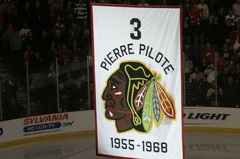 CHICAGO - NOVEMBER 12:  A banner retiring the number of former Chicago Blackhawks defenseman and NHL hall of famer Pierre Pilote is raised during a ceremony before the Chicago Blackhawks Boston Bruins game at the United Center on November 12, 2008 in Chic