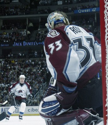 DENVER - APRIL 10:  Darby Hendrickson #14 of the Minnesota Wild takes a shot on goaltender Patrick Roy #33 of the Colorado Avalanche during game one in the first round of the NHL 2003 Stanley Cup playoffs at the Pepsi Center on April 10, 2003 in Denver, C