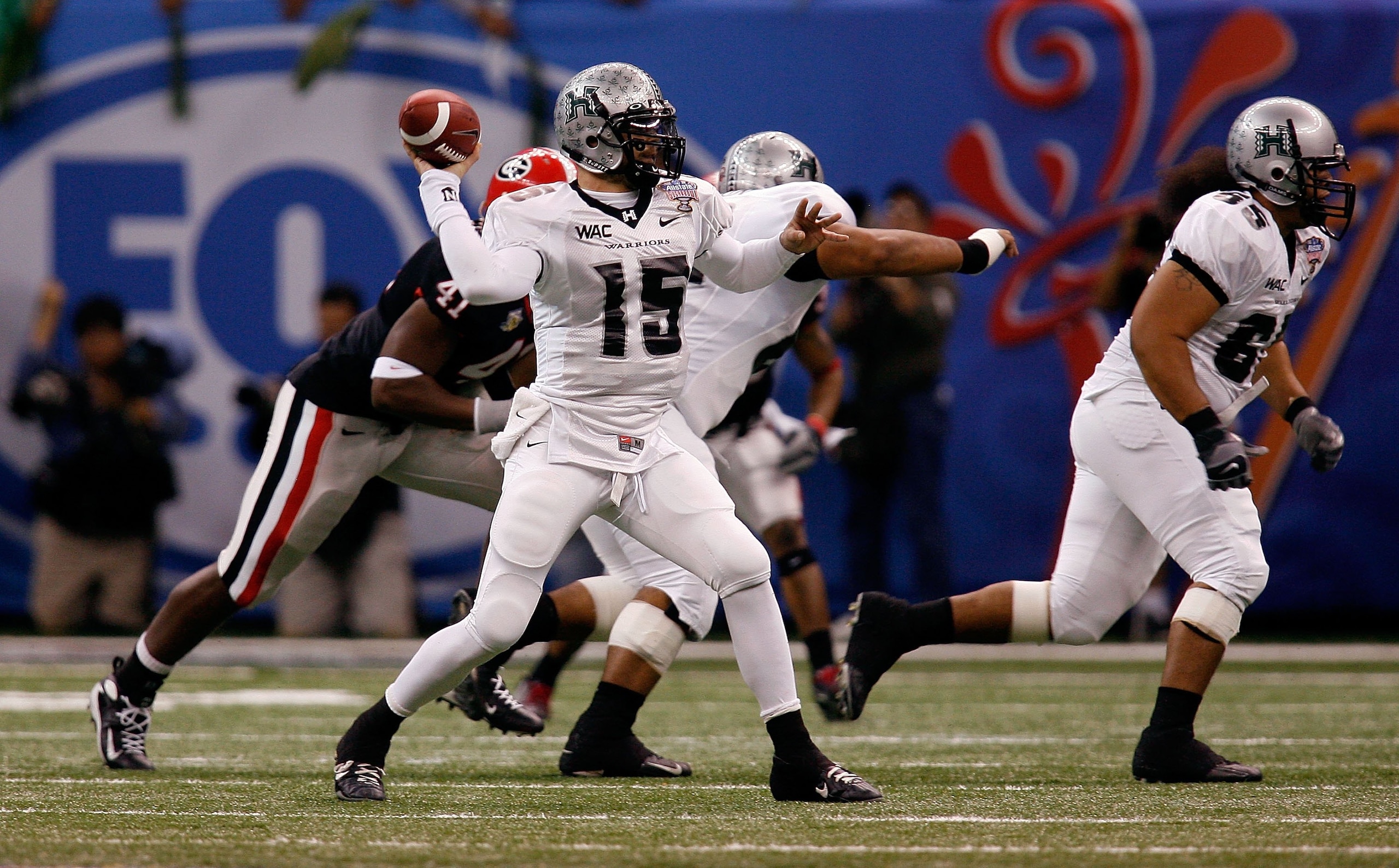 NEW ORLEANS - JANUARY 01:  Colt Brennan #15 of the Hawai'i Warriors throws a pass against the Georgia Bulldogs during the Allstate Sugar Bowl at the Louisiana Superdome on January 1, 2008 in New Orleans, Louisiana. Georgia won 41-10. (Photo by Chris Grayt