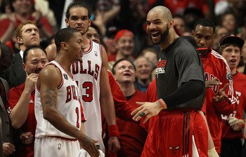 CHICAGO, IL - MAY 15:  (L-R) Derrick Rose #1, Joakim Noah #13 and Carlos Boozer #5 of the Chicago Bulls celebrate late in the fourth quarter against the Miami Heat in Game One of the Eastern Conference Finals during the 2011 NBA Playoffs on May 15, 2011 a