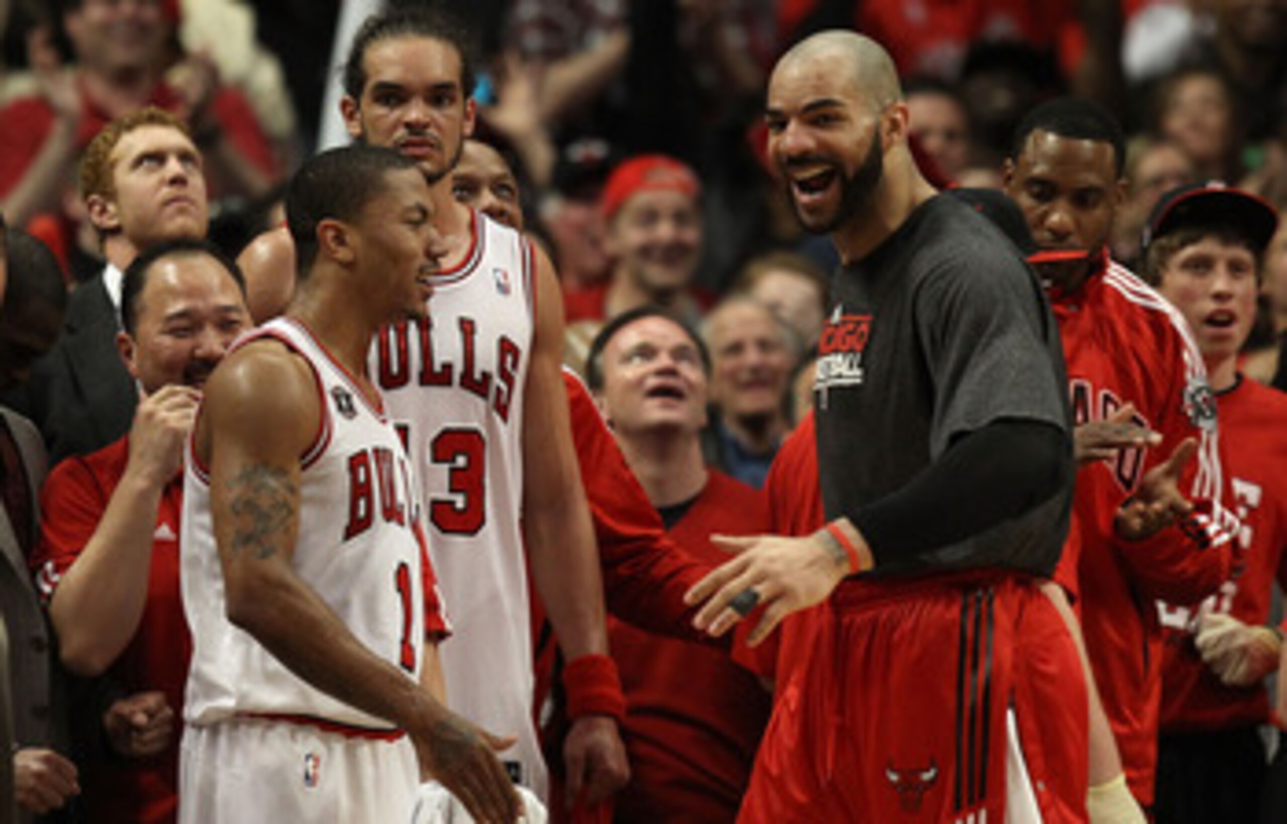 CHICAGO, IL - MAY 15:  (L-R) Derrick Rose #1, Joakim Noah #13 and Carlos Boozer #5 of the Chicago Bulls celebrate late in the fourth quarter against the Miami Heat in Game One of the Eastern Conference Finals during the 2011 NBA Playoffs on May 15, 2011 a
