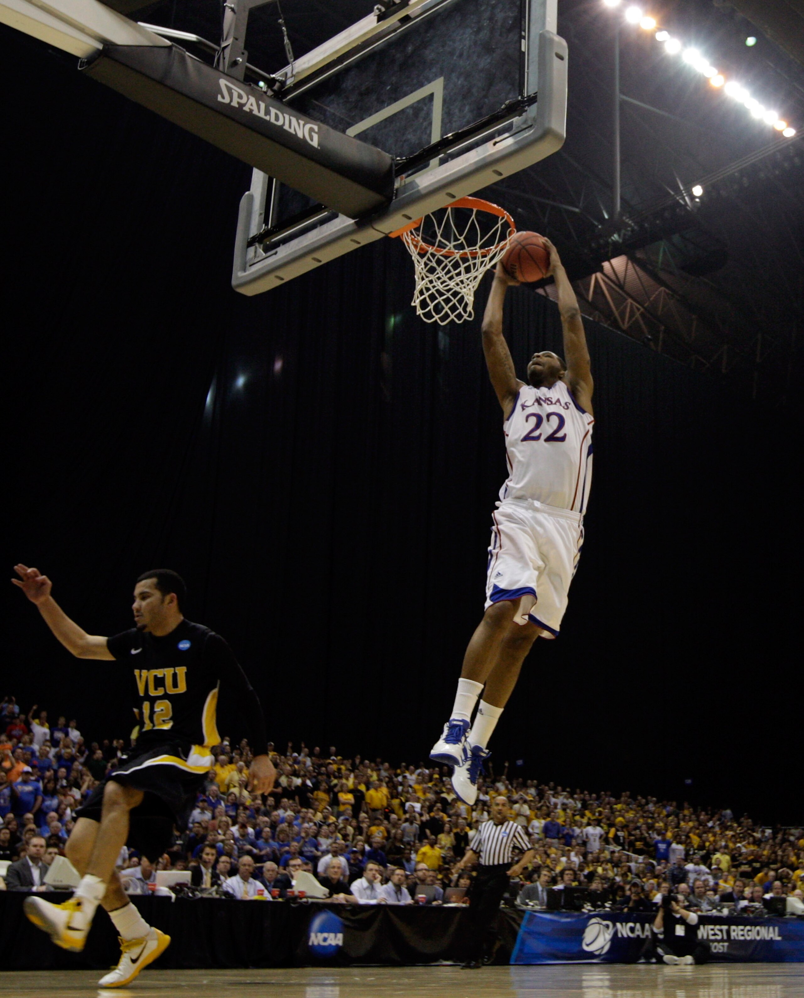 SAN ANTONIO, TX - MARCH 27:  Marcus Morris #22 of the Kansas Jayhawks dunks against Joey Rodriguez #12 of the Virginia Commonwealth Rams during the southwest regional final of the 2011 NCAA men's basketball tournament at the Alamodome on March 27, 2011 in