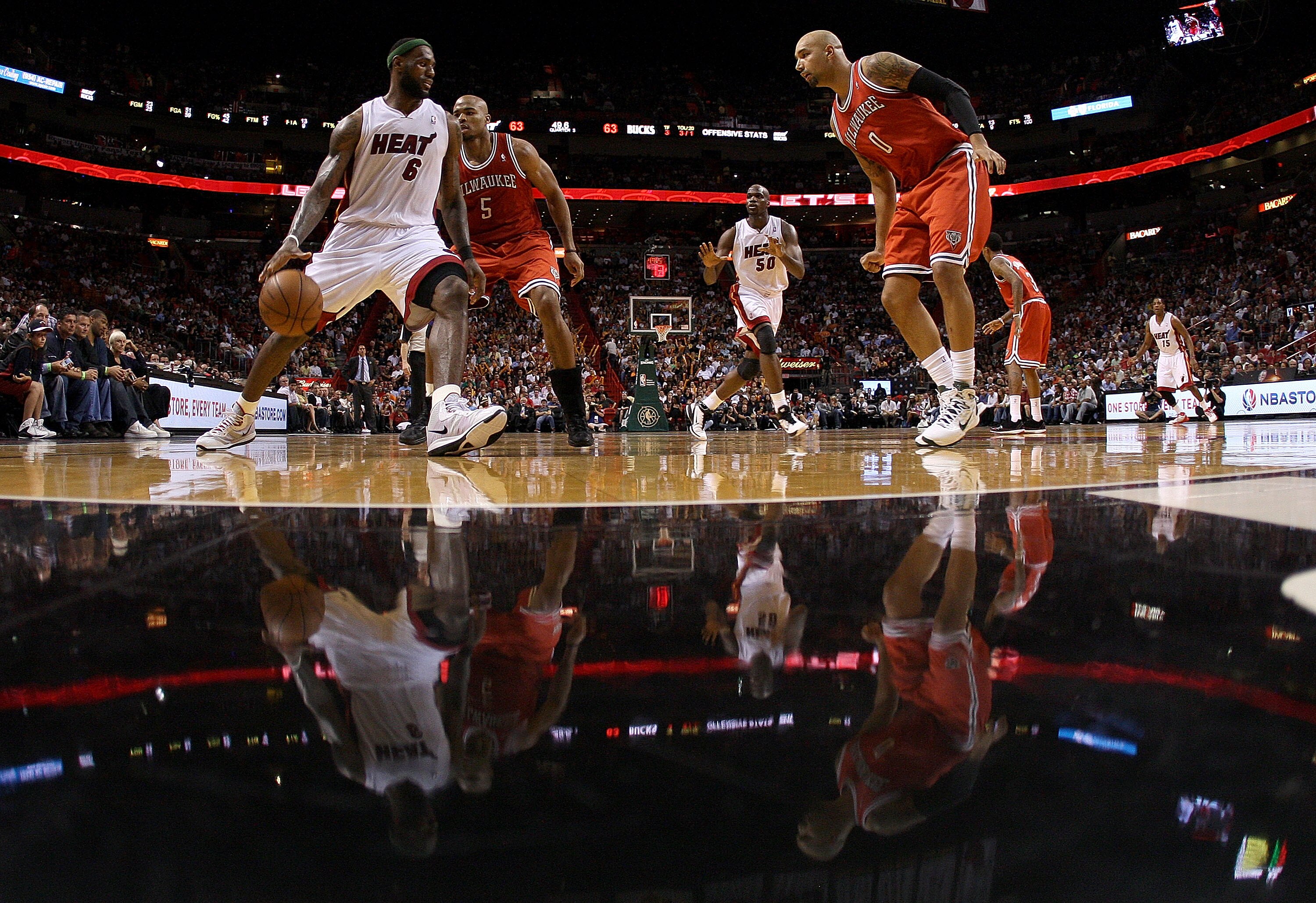 MIAMI, FL - APRIL 06:  Lebron James #6 of the Miami Heat is guarded by Corey Maggette #5 and Drew Gooden #0 of the Milwaukee Bucks during a game at American Airlines Arena on April 6, 2011 in Miami, Florida. NOTE TO USER: User expressly acknowledges and a