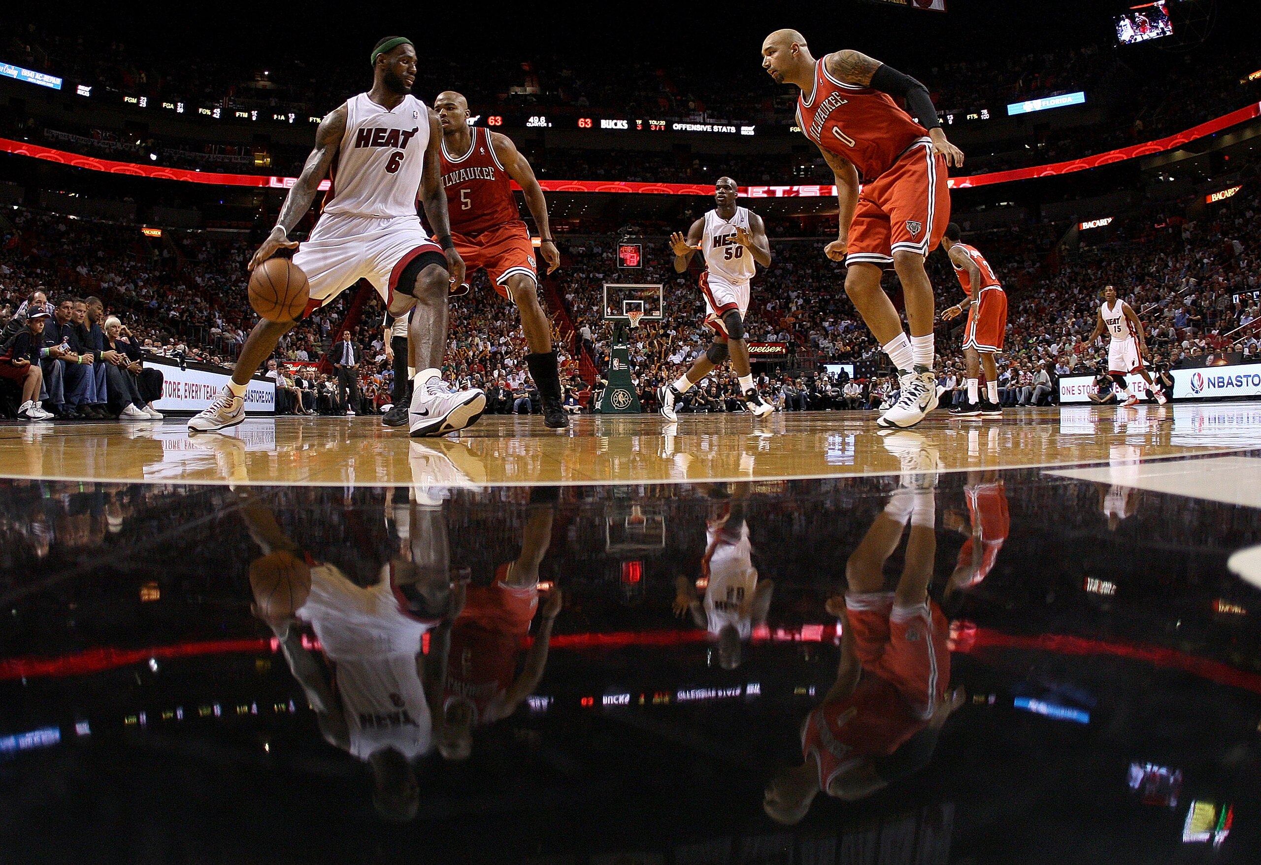 MIAMI, FL - APRIL 06:  Lebron James #6 of the Miami Heat is guarded by Corey Maggette #5 and Drew Gooden #0 of the Milwaukee Bucks during a game at American Airlines Arena on April 6, 2011 in Miami, Florida. NOTE TO USER: User expressly acknowledges and a