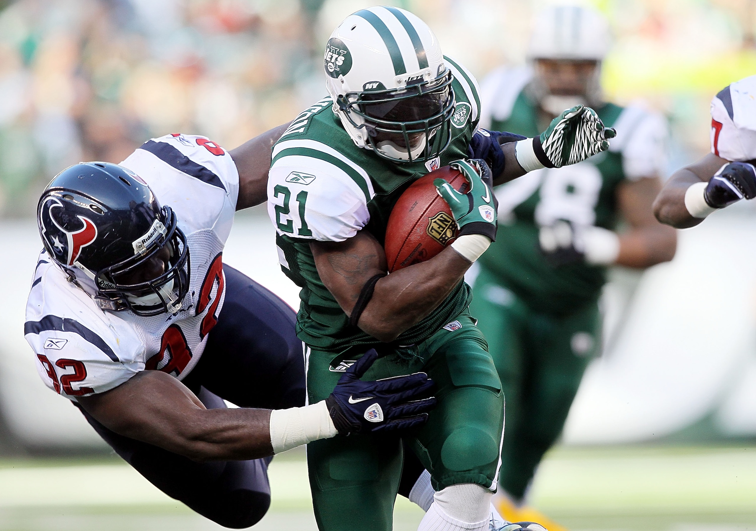 EAST RUTHERFORD, NJ - NOVEMBER 21:  LaDainian Tomlinson #21 of the New York Jets runs the ball against Earl Mitchell #92 of the Houston Texans on November 21, 2010 at the New Meadowlands Stadium in East Rutherford, New Jersey.  (Photo by Jim McIsaac/Getty