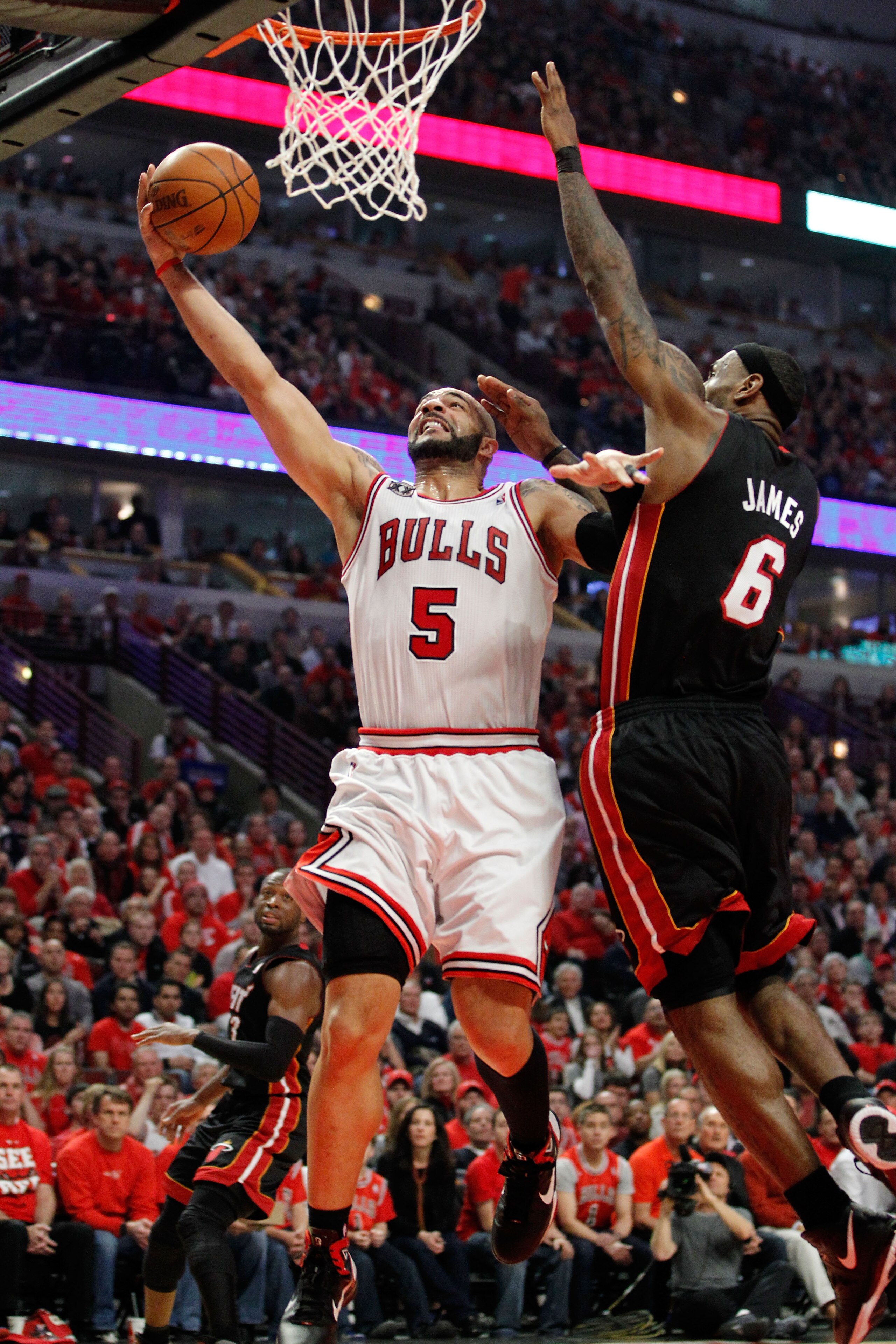 CHICAGO, IL - MAY 15:  Carlos Boozer #5 of the Chicago Bulls drives for a shot attempt against LeBron James #6 of the Miami Heat in Game One of the Eastern Conference Finals during the 2011 NBA Playoffs on May 15, 2011 at the United Center in Chicago, Ill
