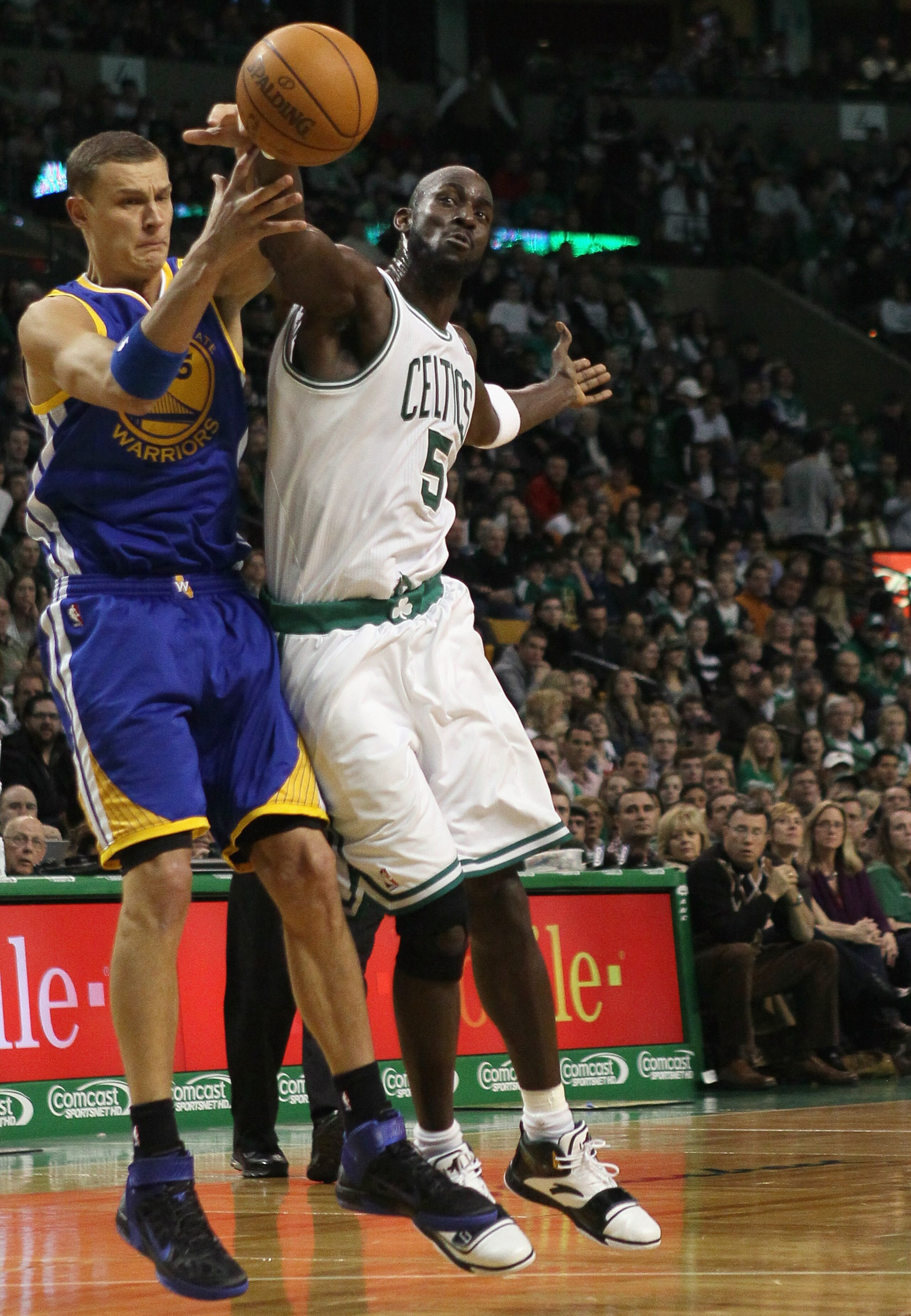 BOSTON, MA - MARCH 04:  Kevin Garnett #5 of the Boston Celtics tries to keep the ball from Andris Biedrins #15 of the Golden State Warriors on March 4, 2011 at the TD Garden in Boston, Massachusetts.  NOTE TO USER: User expressly acknowledges and agrees t