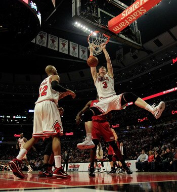 CHICAGO, IL - JANUARY 15: Omer Asik #3 of the Chicago Bulls dunks the ball against the Miami Heat as teammate Taj Gibson #22 watches at the United Center on December 28, 2011 in Chicago, Illinois. The Bulls defeated the Heat 99-96. NOTE TO USER: User expr