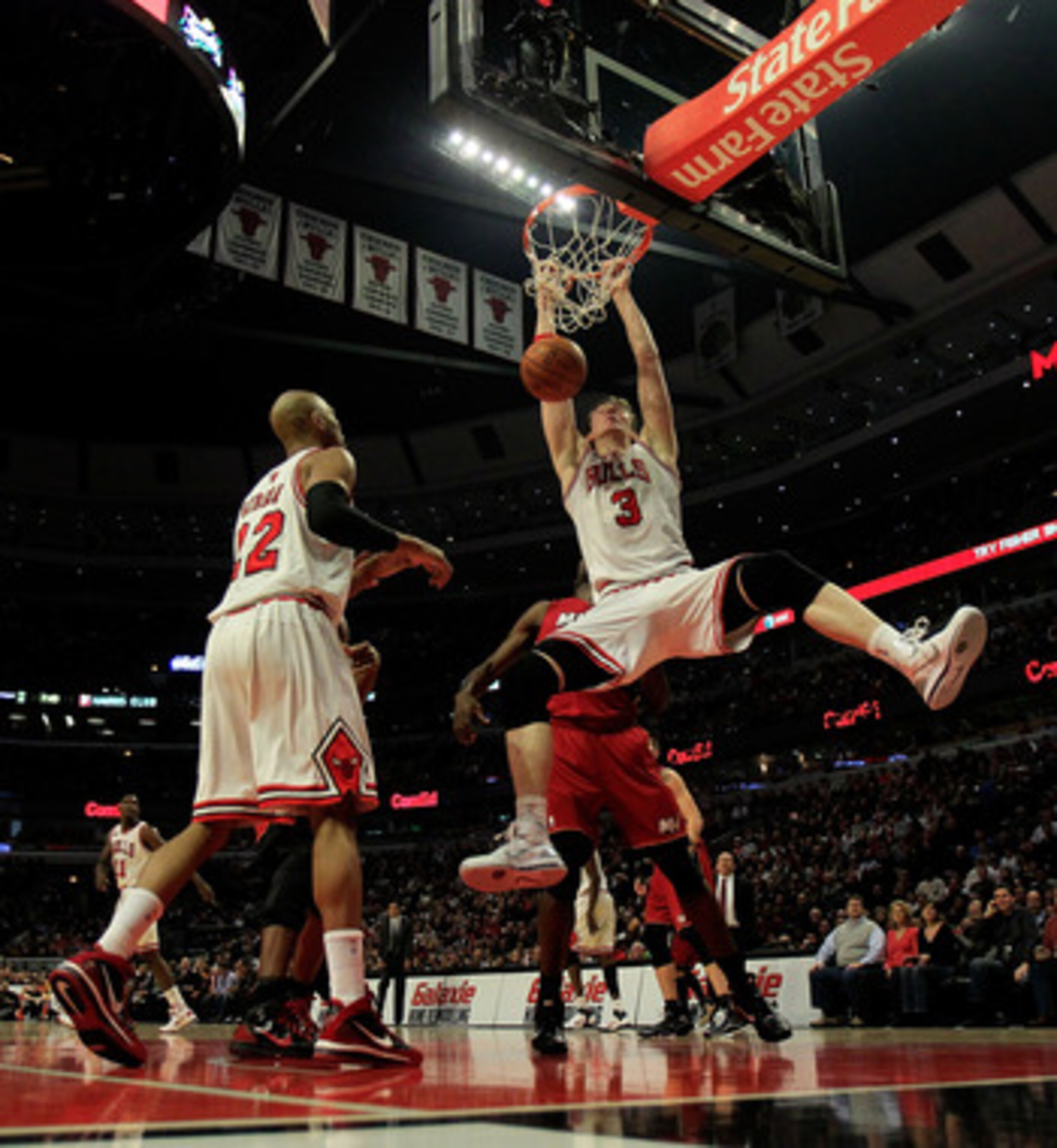 CHICAGO, IL - JANUARY 15: Omer Asik #3 of the Chicago Bulls dunks the ball against the Miami Heat as teammate Taj Gibson #22 watches at the United Center on December 28, 2011 in Chicago, Illinois. The Bulls defeated the Heat 99-96. NOTE TO USER: User expr