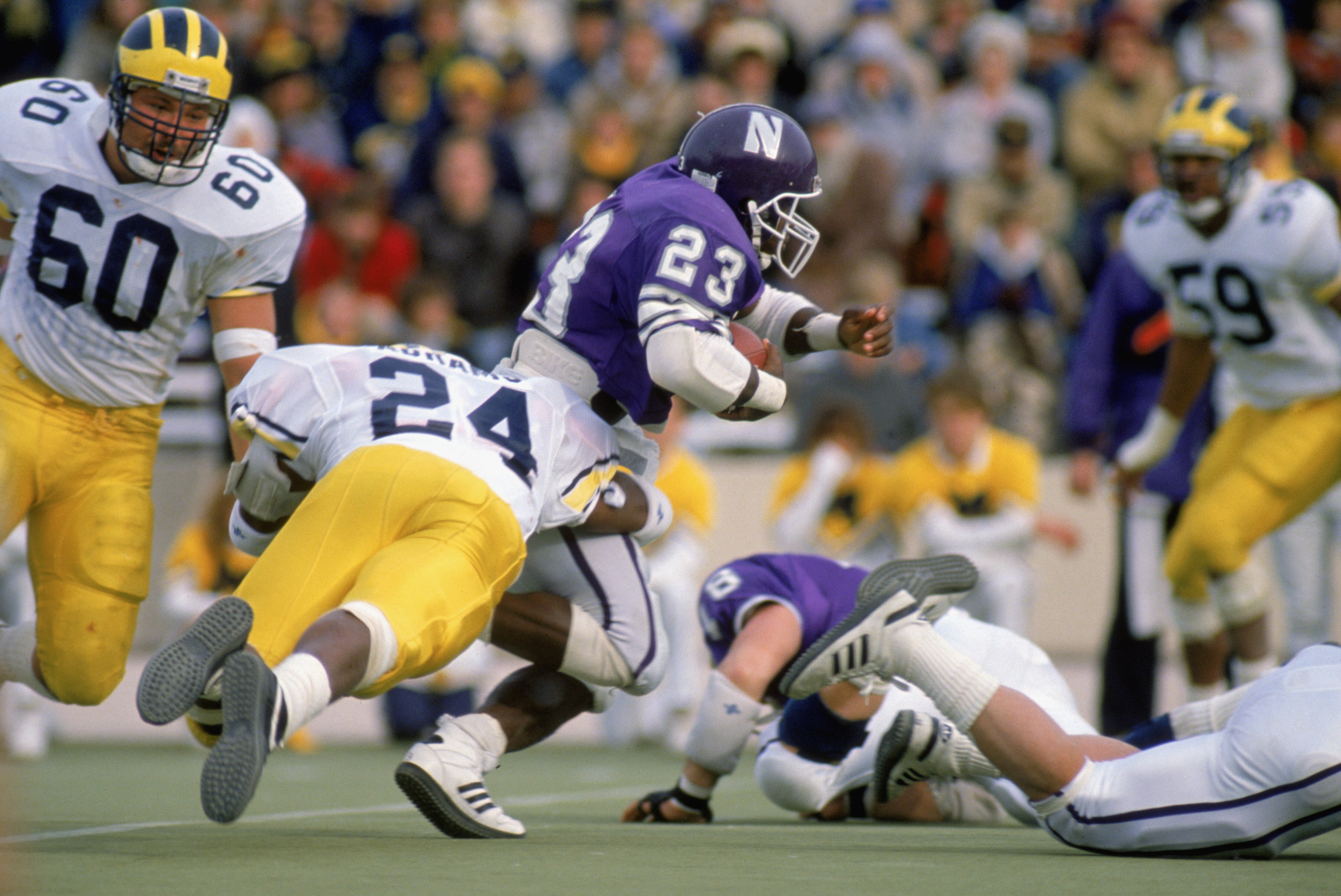 1988:  Byron Sanders #23 of Northwestern University Wildcats carries the ball during a game against the University of Michigan Wolverines in the 1988 season. (Photo by: Jonathan Daniel/Getty Images)