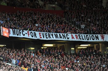 MANCHESTER, ENGLAND - MAY 04: Manchester United fans support their team during the UEFA Champions League Semi Final second leg match between Manchester United and Schalke at Old Trafford on May 4, 2011 in Manchester, England. (Photo by Michael Regan/Getty