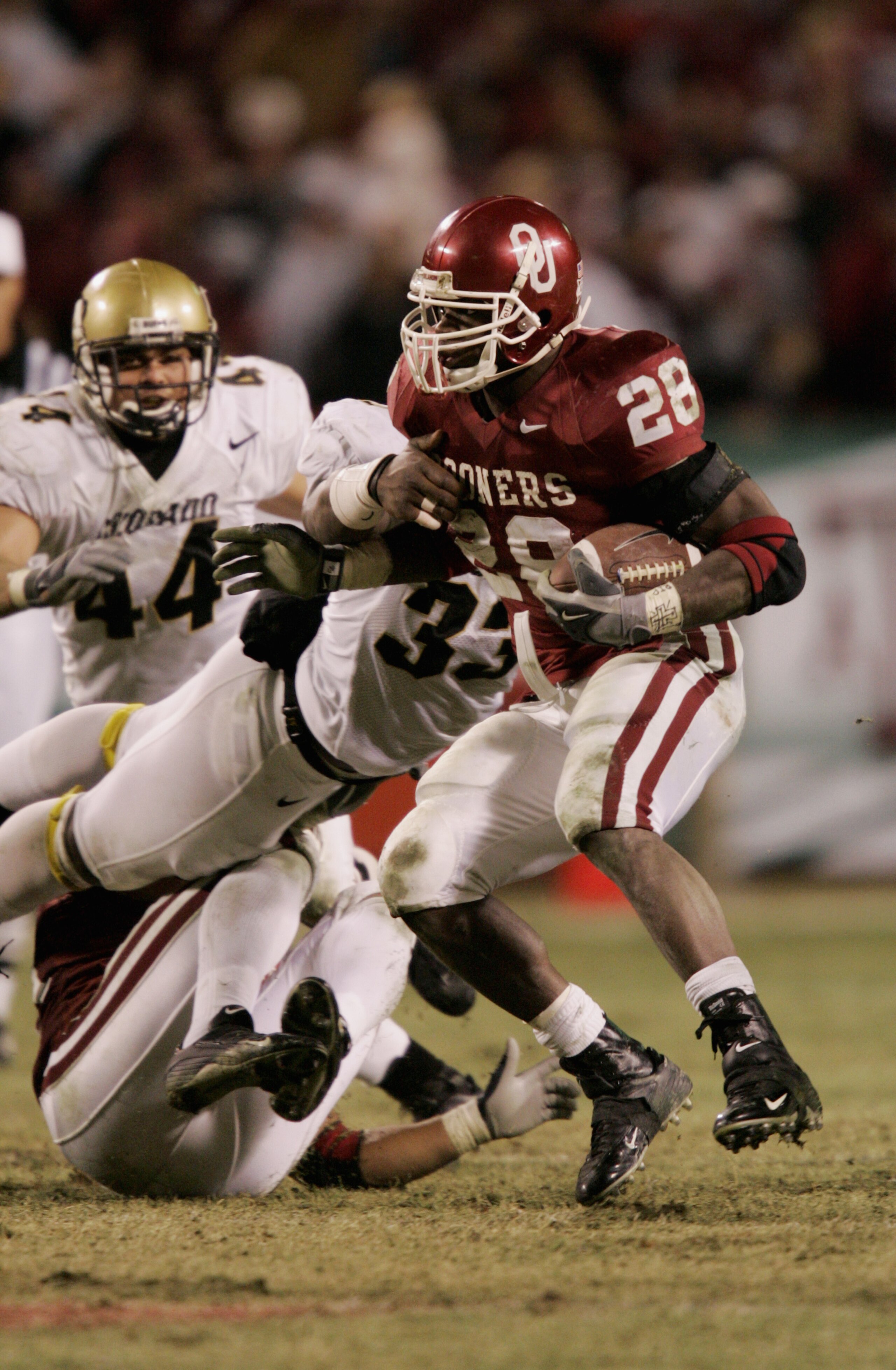KANSAS CITY, MO - DECEMBER 4:  Adrian Peterson #28 of the University of Oklahoma Sooners carries the ball against the University of Colorado Buffaloes in the Big 12 Championship game on December 4, 2004 at Arrowhead Stadium in Kansas City, Missouri.  Okla