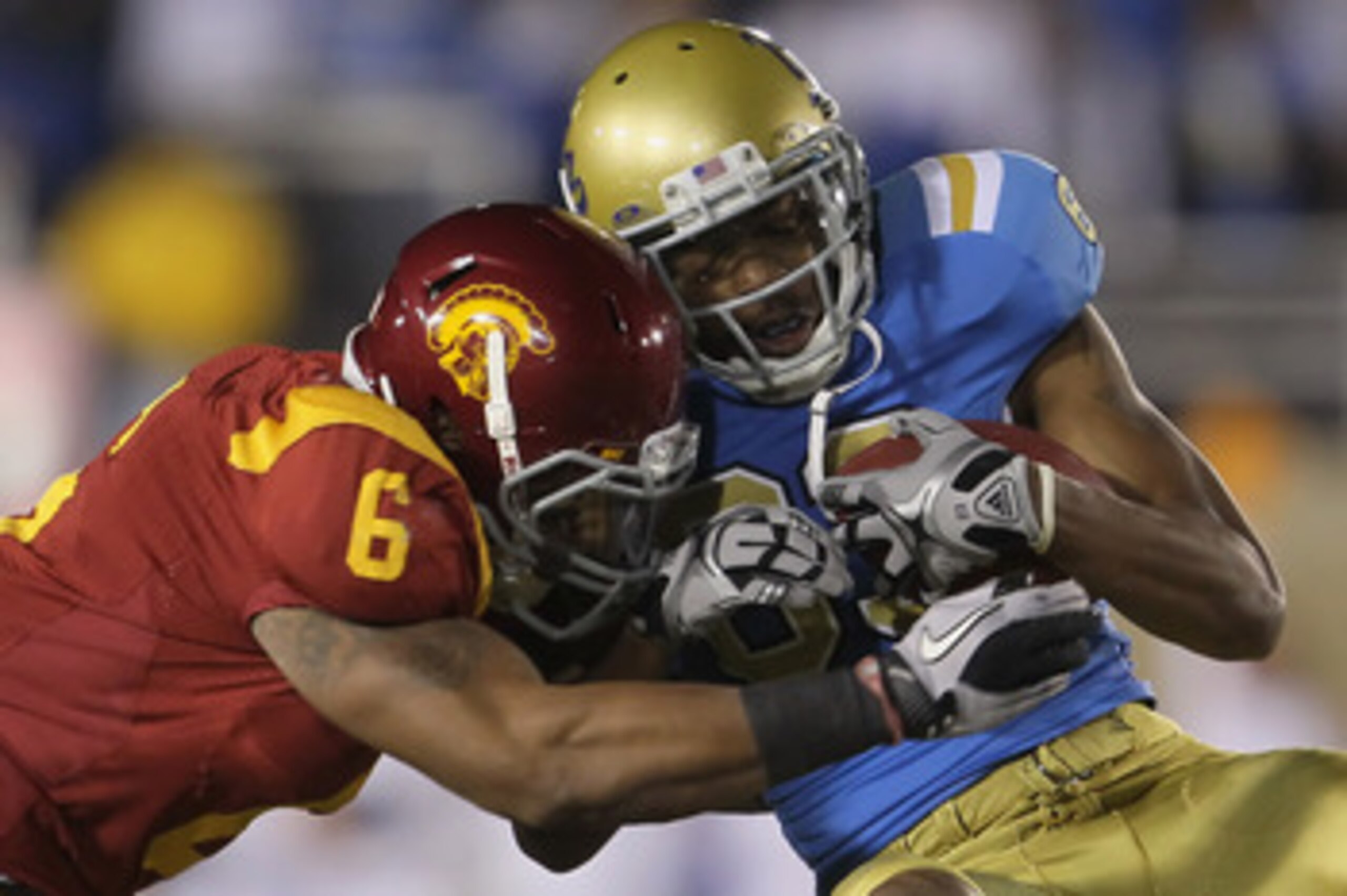 PASADENA, CA - DECEMBER 04:  Malcolm Smith #6 of the USC Trojans tackles Nelson Rosario #83 of the UCLA Bruins during the first half at the Rose Bowl on December 4, 2010 in Pasadena, California. USC defeated UCLA 28-14.  (Photo by Jeff Gross/Getty Images)