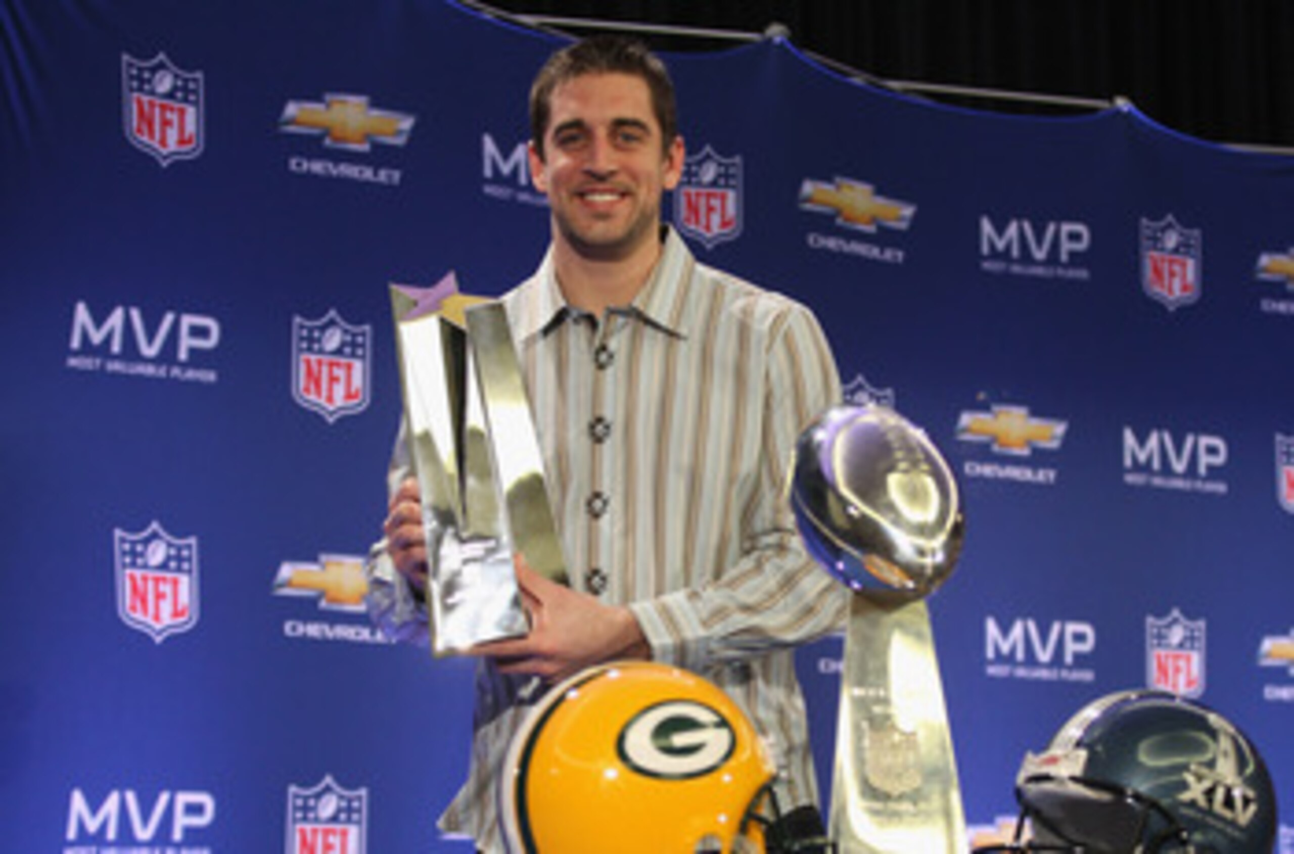 DALLAS, TX - FEBRUARY 07:  Green Bay Packers quarterback Aaron Rodgers poses with the MVP trophy after speaking to the media during a press conference at Super Bowl XLV Media Center on February 7, 2011 in Dallas, Texas.  (Photo by Streeter Lecka/Getty Ima