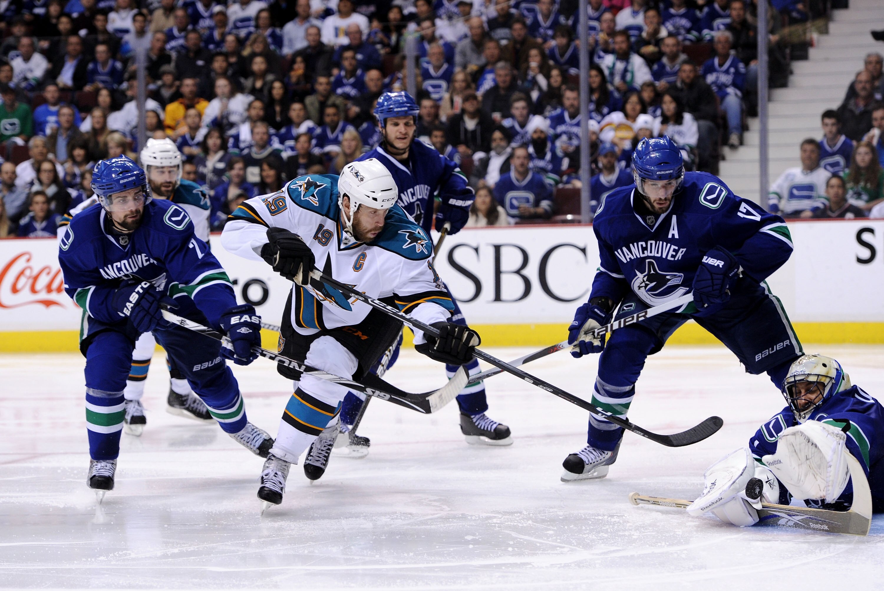 VANCOUVER, CANADA - MAY 15:  Goaltender Roberto Luongo #1 of the Vancouver Canucks makes a save on a backhand shot by Joe Thornton #19 of the San Jose Sharks as Ryan Kesler #17 and Dan Hamhuis #2 of the Vancouver Canucks look on in Game One of the Western