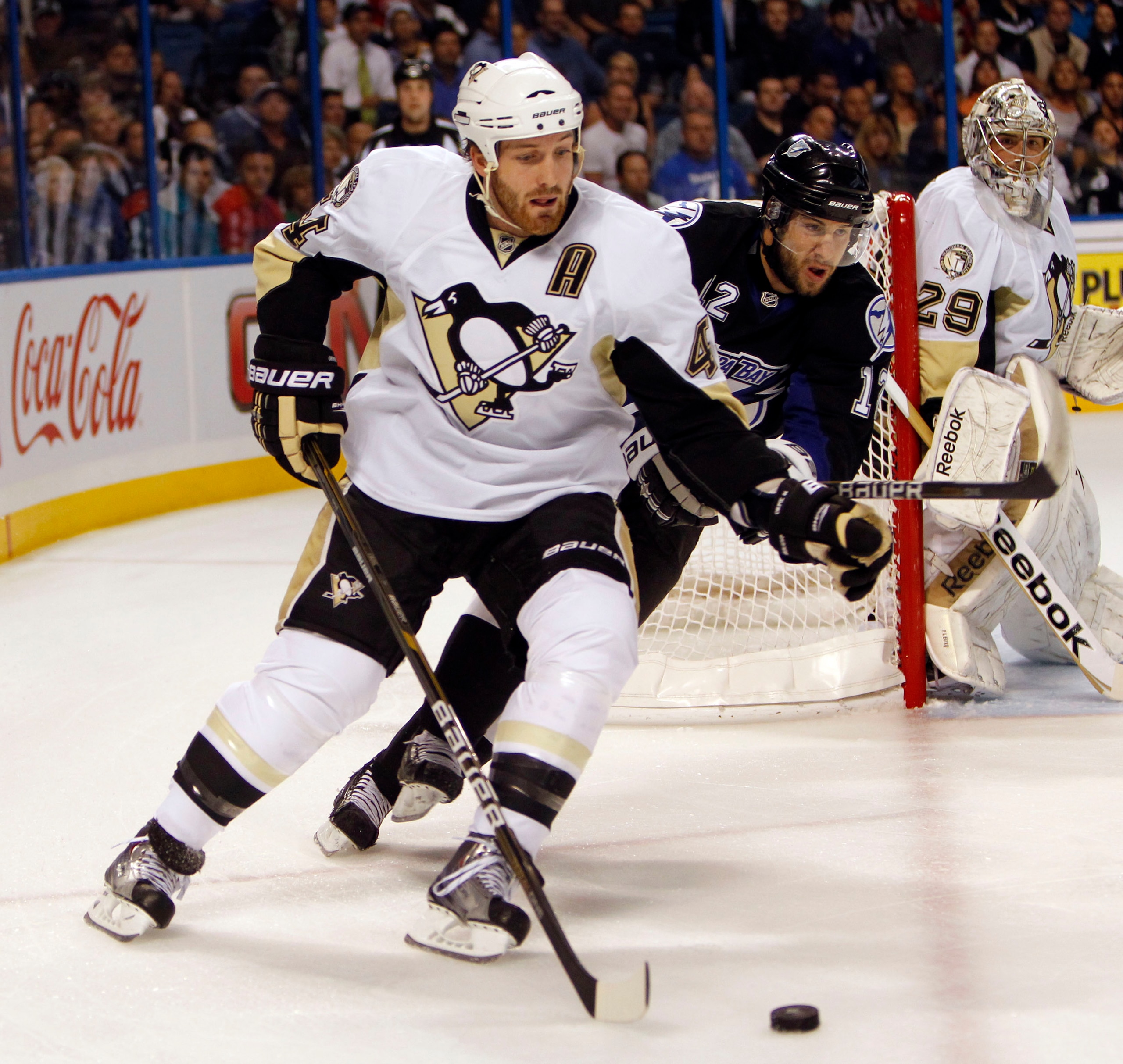 TAMPA, FL - APRIL 25: Brooks Orpik #44 of the Pittsburgh Penguins skates with the puck against Simon Gagne #12 of the Tampa Bay Lightning in Game Six of the Eastern Conference Quarterfinals during the 2011 NHL Stanley Cup Playoffs at the St. Pete Times Fo TAMPA, FL - APRIL 25: Brooks Orpik #44 of the Pittsburgh Penguins skates with the puck against Simon Gagne #12 of the Tampa Bay Lightning in Game Six of the Eastern Conference Quarterfinals during the 2011 NHL Stanley Cup Playoffs at the St. Pete Times Fo