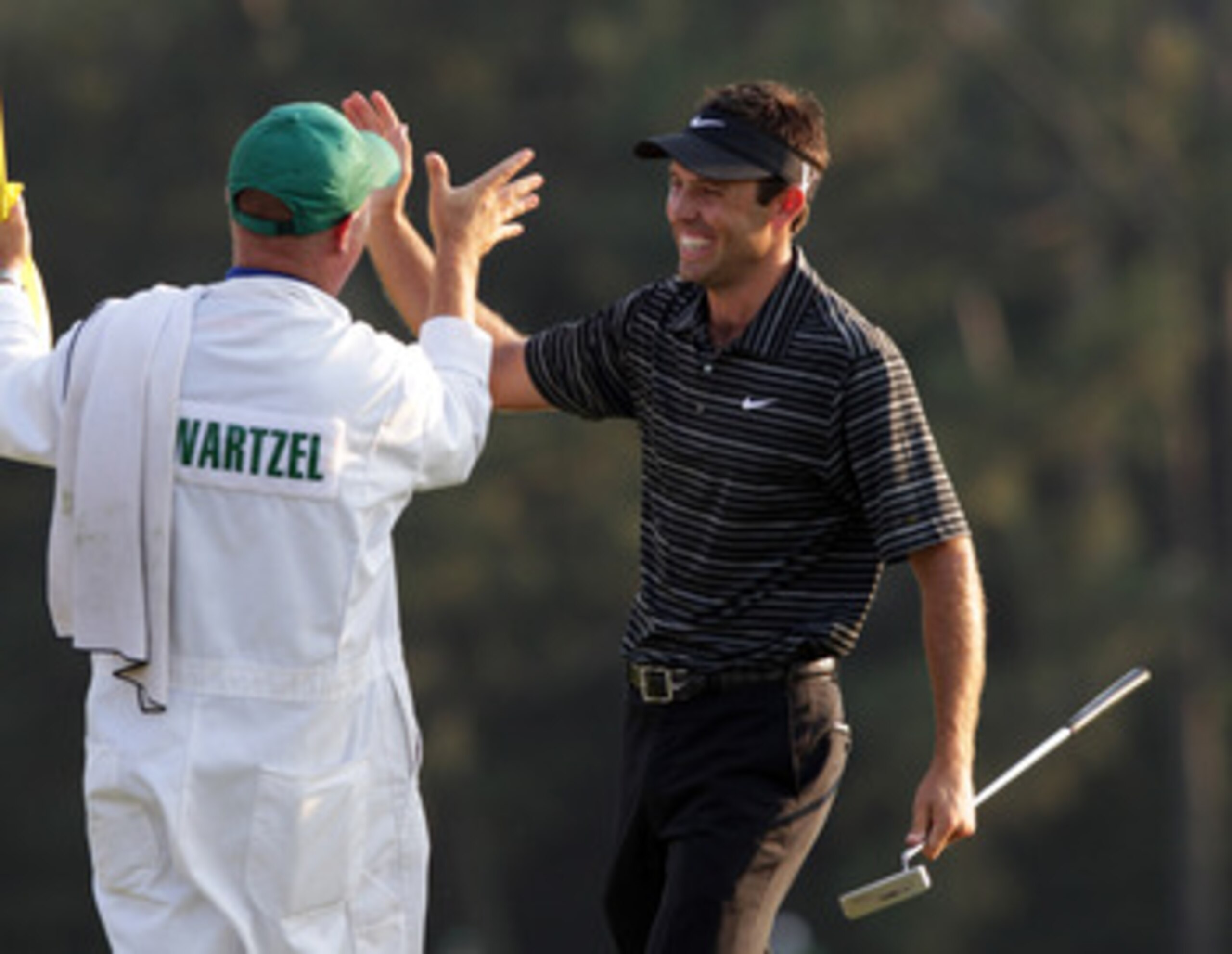 AUGUSTA, GA - APRIL 10:  Charl Schwartzel of South Africa celebrates his birdie on the 18th green with his caddie Greg Hearmon and winning the Masters during the final round of the 2011 Masters Tournament at Augusta National Golf Club on April 10, 2011 in