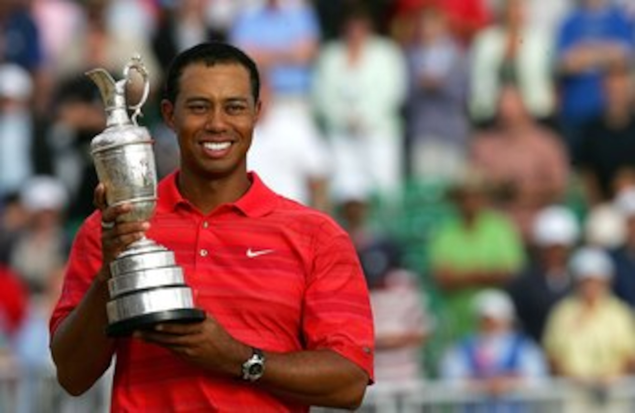 HOYLAKE, UNITED KINGDOM - JULY 23:  Tiger Woods of USA poses with the claret jug following his two shot victory at the end of the final round of The Open Championship at Royal Liverpool Golf Club on July 23, 2006 in Hoylake, England.  (Photo by David Cann