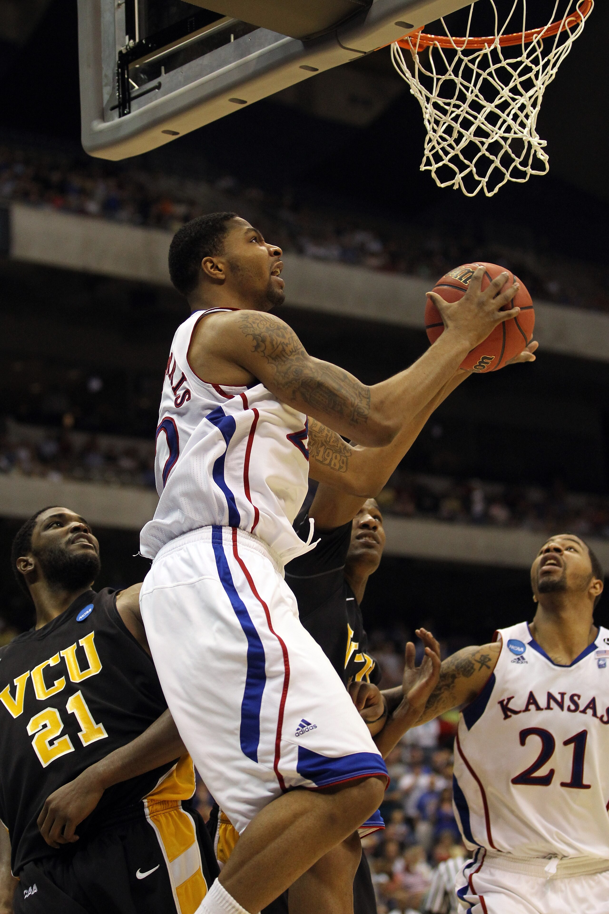 SAN ANTONIO, TX - MARCH 27:  Marcus Morris #22 of the Kansas Jayhawks goes to the basket against Jamie Skeen #21 of the Virginia Commonwealth Rams during the southwest regional final of the 2011 NCAA men's basketball tournament at the Alamodome on March 2