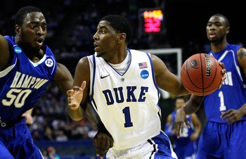 CHARLOTTE, NC - MARCH 18:  Kyrie Irving #1 of the Duke Blue Devils drives on Milade Lola-Charles #50 of the Hampton Pirates in the first half during the second round of the 2011 NCAA men's basketball tournament at Time Warner Cable Arena on March 18, 2011