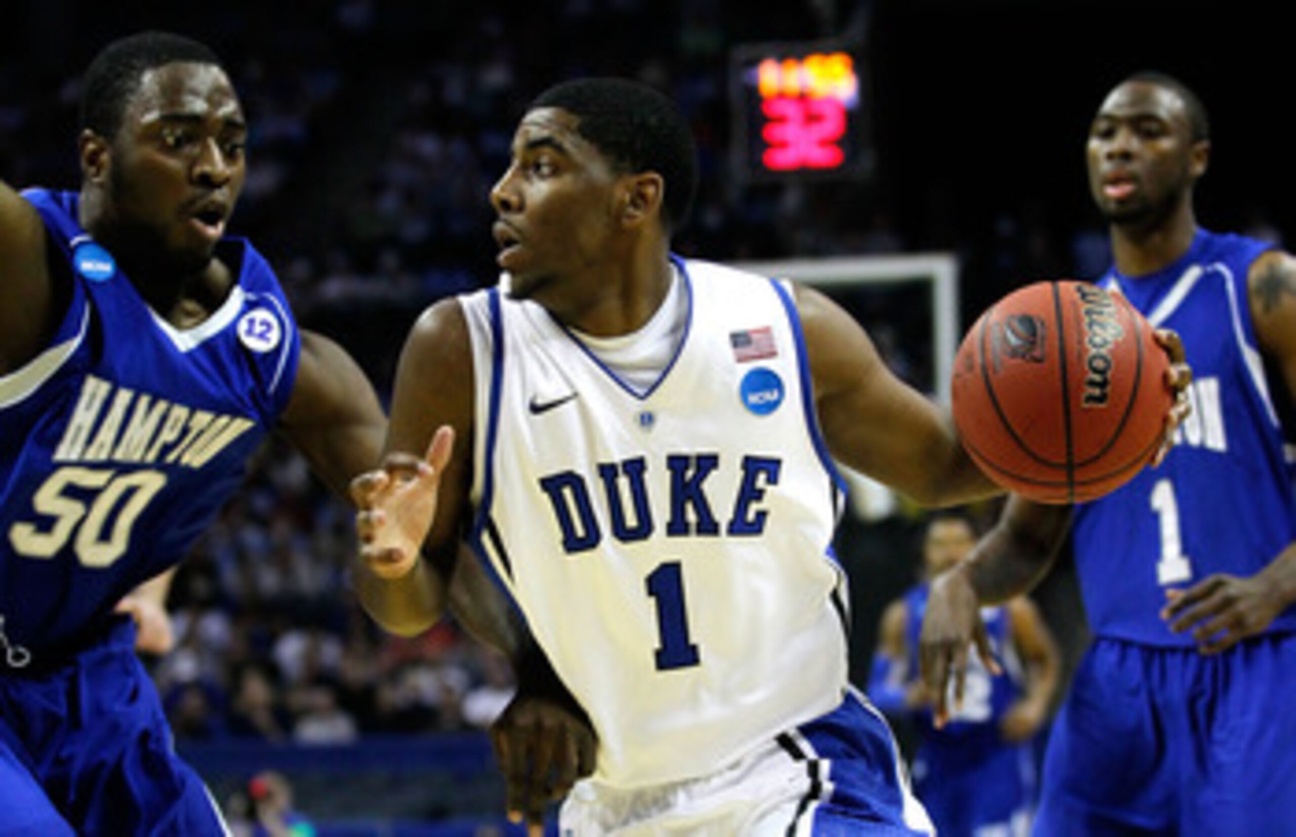 CHARLOTTE, NC - MARCH 18:  Kyrie Irving #1 of the Duke Blue Devils drives on Milade Lola-Charles #50 of the Hampton Pirates in the first half during the second round of the 2011 NCAA men's basketball tournament at Time Warner Cable Arena on March 18, 2011