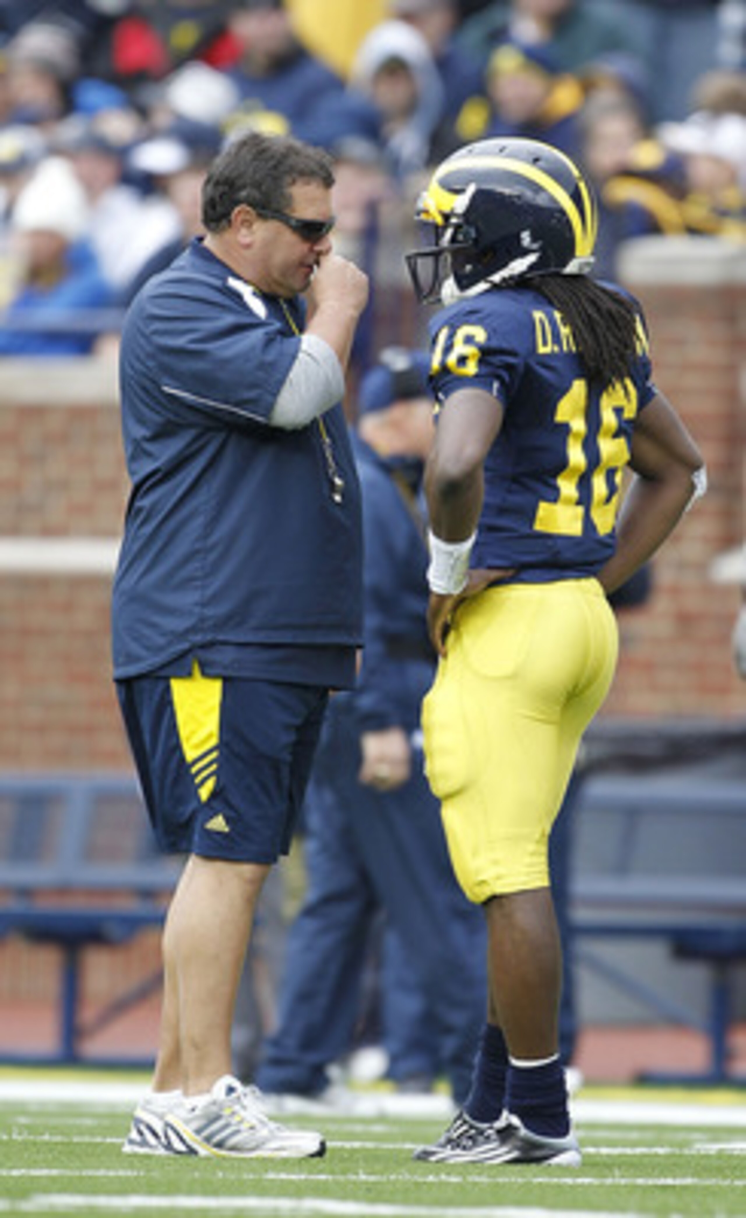 ANN ARBOR, MI - APRIL 16:  Head football coach Brady Hoke talks with Denard Robinson #16 during the annual Spring Game at Michigan Stadium on April 16, 2011 in Ann Arbor, Michigan.  (Photo by Leon Halip/Getty Images)