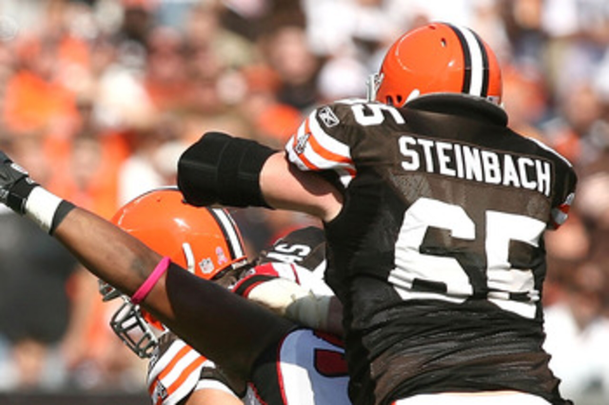 CLEVELAND - OCTOBER 10:  Quarterback Seneca Wallace #6 of the Cleveland Browns gets a block from Eric Steinbach #65 as he runs from defender Kroy Biermann #71 of the Atlanta Falcons at Cleveland Browns Stadium on October 10, 2010 in Cleveland, Ohio.  (Pho