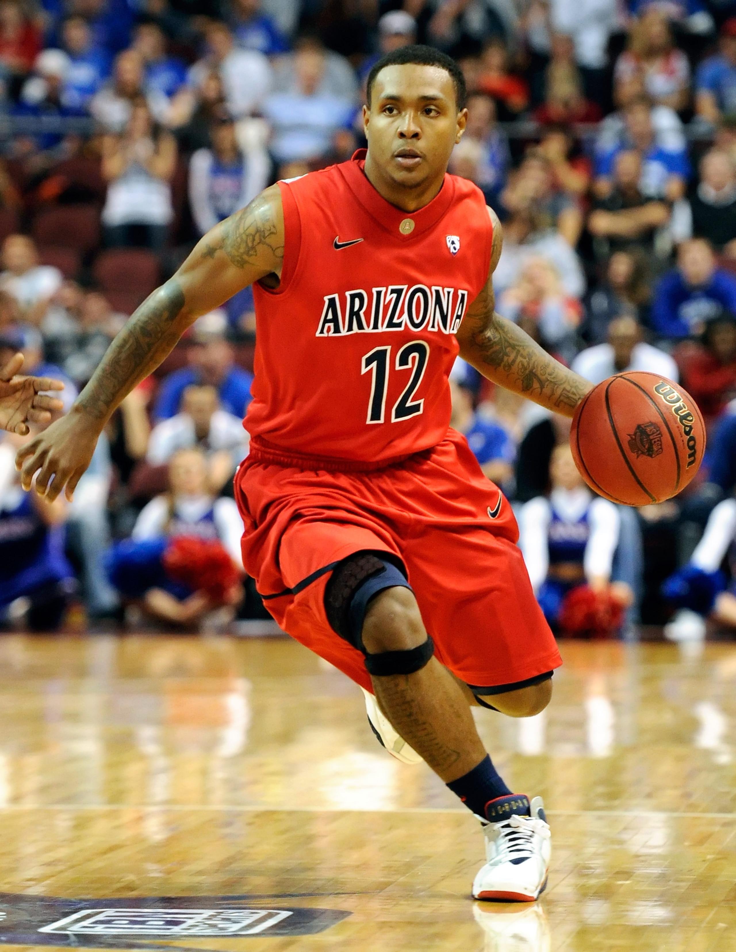 LAS VEGAS - NOVEMBER 27: Lamont Jones #12 of the Arizona Wildcats drives against the Kansas Jayhawks during the championship game of the Las Vegas Invitational at The Orleans Arena November 27, 2010 in Las Vegas, Nevada. Kansas won 87-79. (Photo by Etha LAS VEGAS - NOVEMBER 27: Lamont Jones #12 of the Arizona Wildcats drives against the Kansas Jayhawks during the championship game of the Las Vegas Invitational at The Orleans Arena November 27, 2010 in Las Vegas, Nevada. Kansas won 87-79. (Photo by Etha