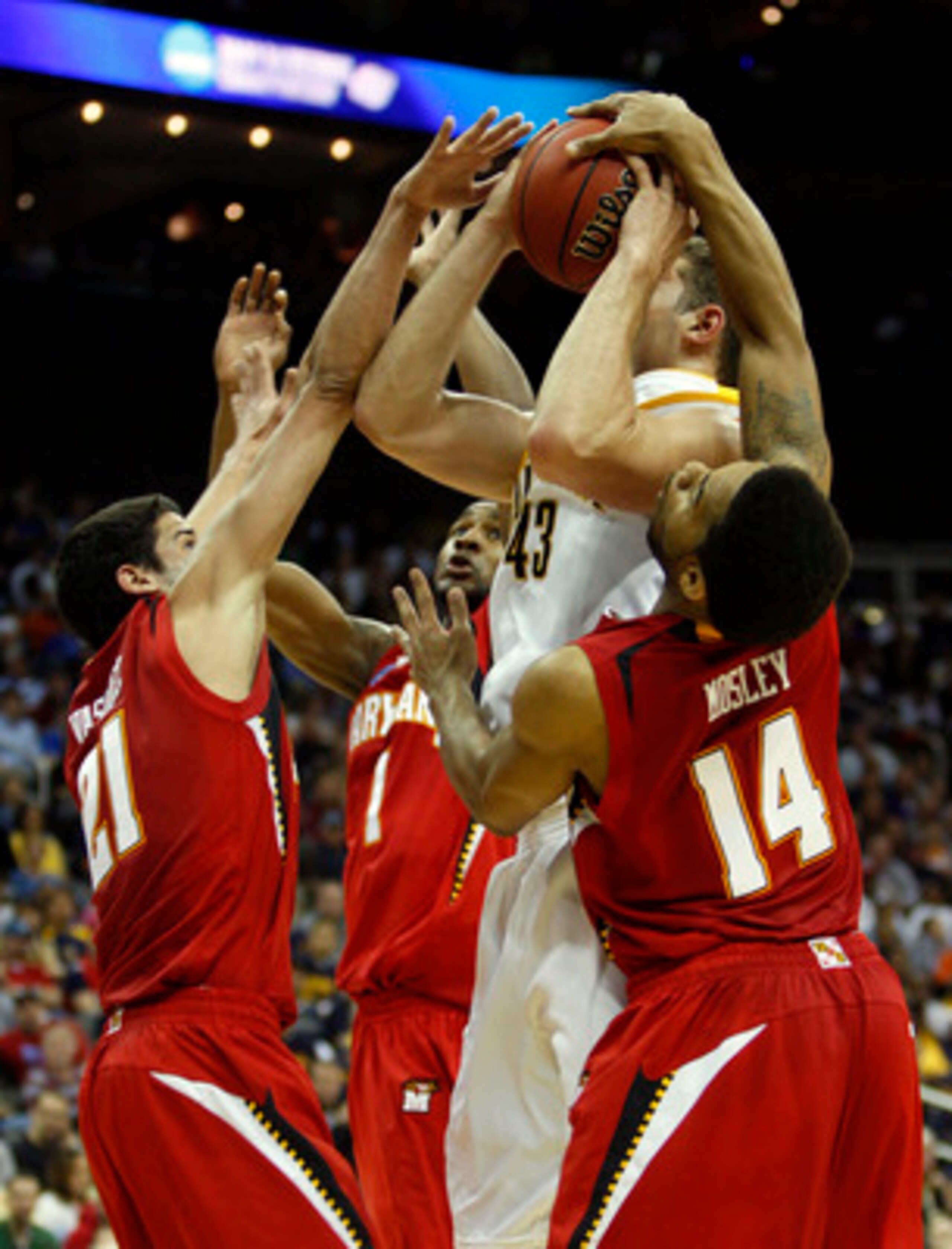 KANSAS CITY, MO - MARCH 19:  Greivis Vasquez #21, Landon Milbourne #1 and Sean Mosley #14 of the Maryland Terrapins defend a shot attempt by Harper Kamp #43 of the California Golden Bears in the first half during the first round of the NCAA Division I Men