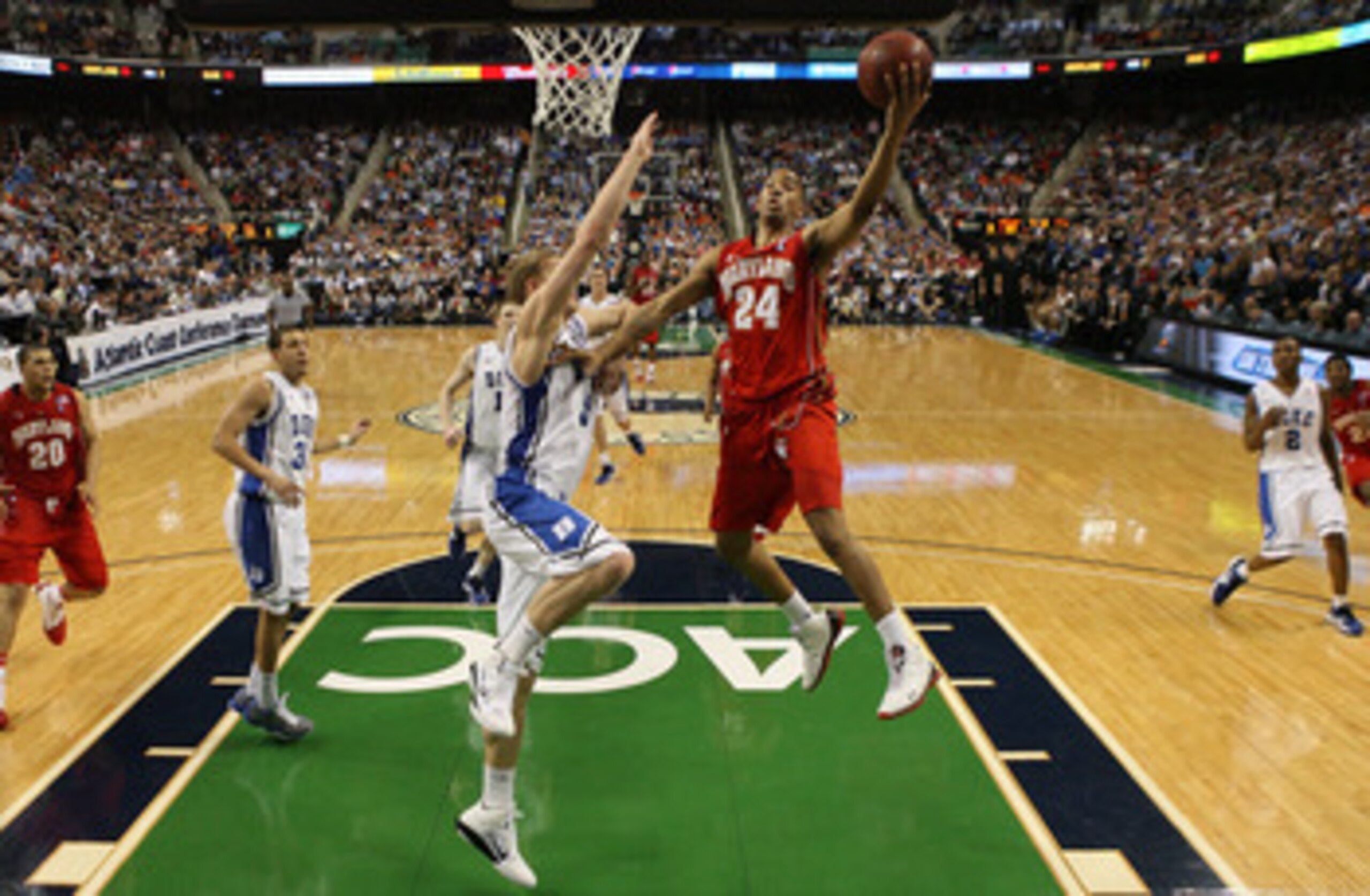 GREENSBORO, NC - MARCH 11:  Cliff Tucker #24 of the Maryland Terrapins shoots against Mason Plumlee #5 of the Duke Blue Devils during the quarterfinals of the 2011 ACC men's basketball tournament at the Greensboro Coliseum on March 11, 2011 in Greensboro,