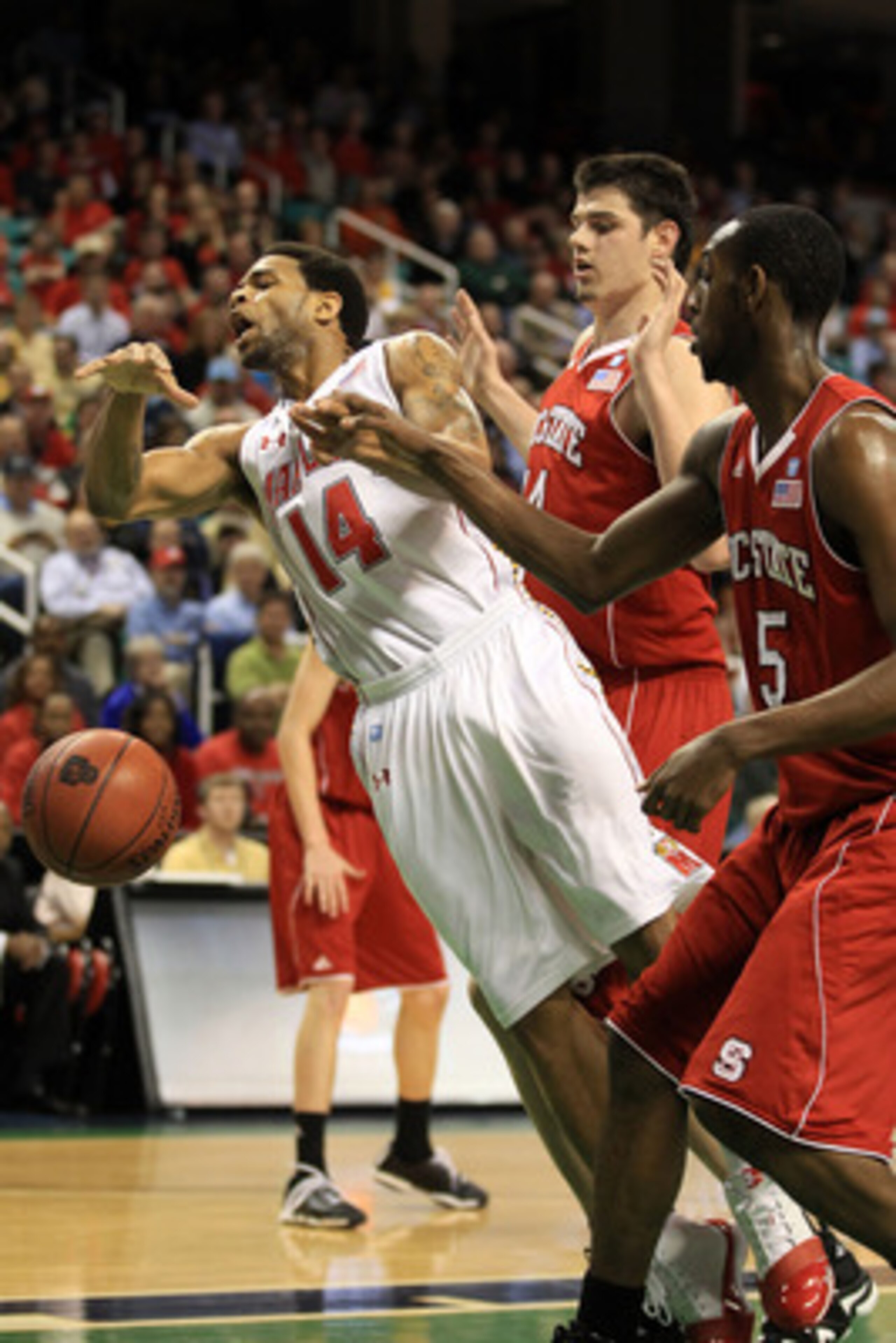 GREENSBORO, NC - MARCH 10:  Sean Mosley #14 of the Maryland Terrapins loses possession of the ball against Jordan Vandenberg #14 and C.J. Leslie #5 of the North Carolina State Wolfpack during the first half of the game in the first round of the 2011 ACC m