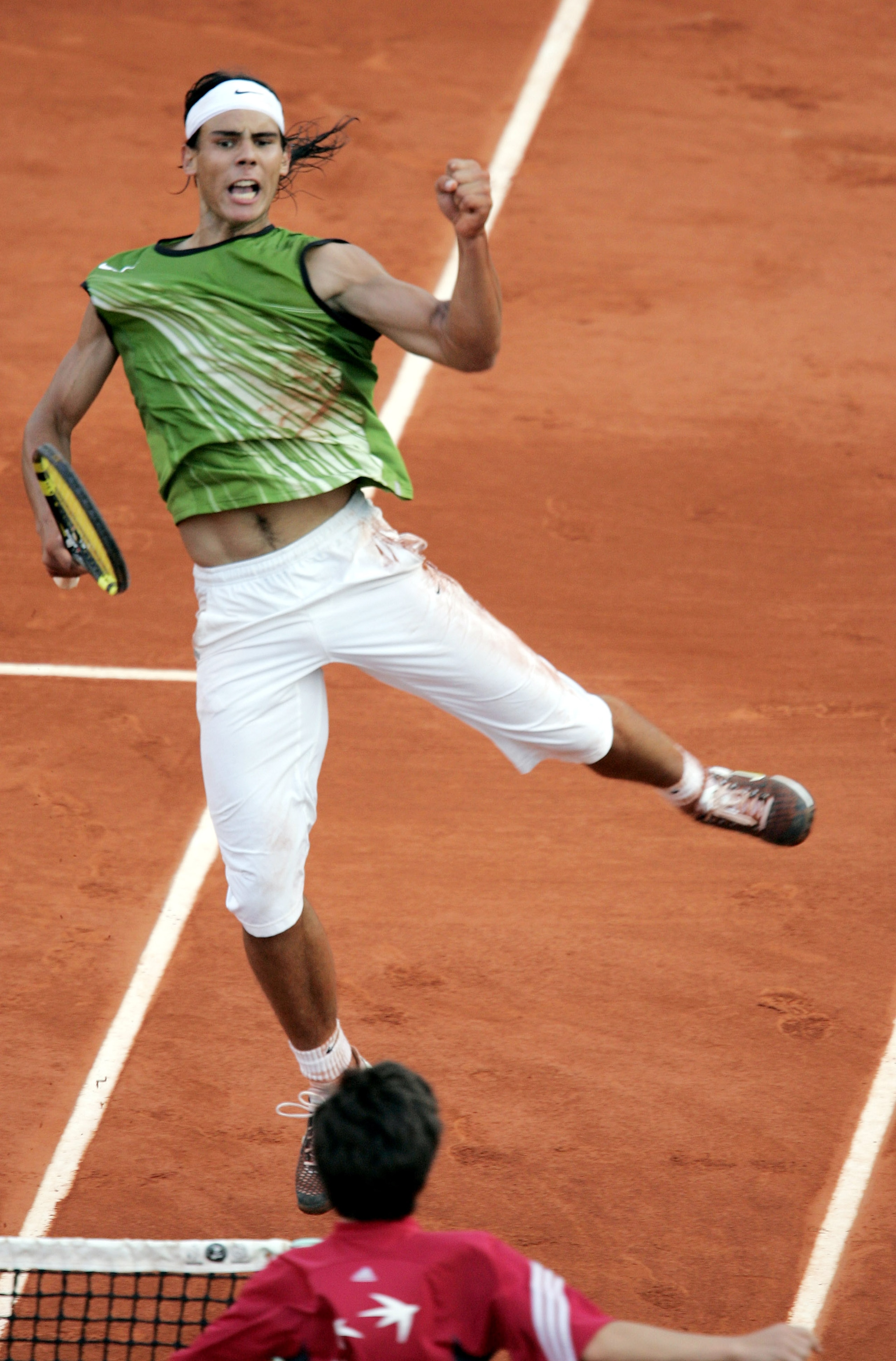 PARIS - JUNE 3:  Rafael Nadal of Spain celebrates winning a point during his semi-final match against Roger Federer of Switzerland during the twelfth day of the French Open at Roland Garros on June 3, 2005 in Paris, France. (Photo by Clive Mason/Getty Ima