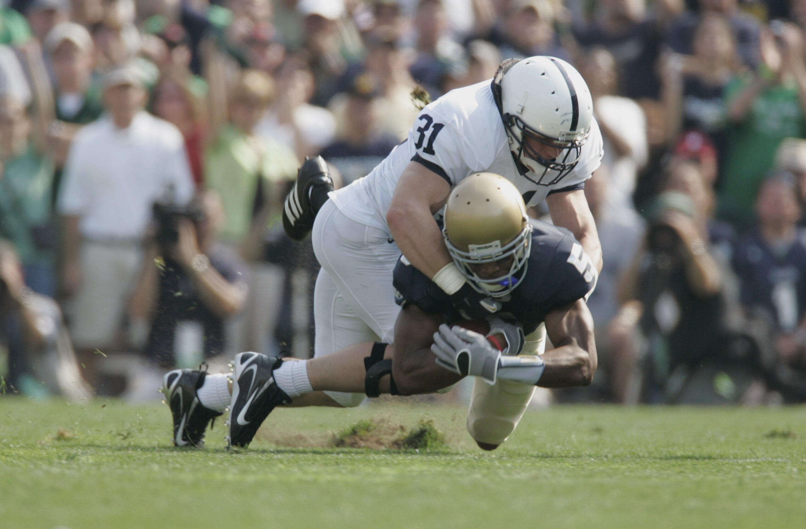 SOUTH BEND, IN - SEPTEMBER 9:  Wide receiver Rhema McKnight #5 of the Notre Dame Fighting Irish is tackled by linebacker Paul Posluszny #31 of the Penn State Nittany Lions on September 9, 2006 at Notre Dame Stadium in South Bend, Indiana. (Photo By Gregor