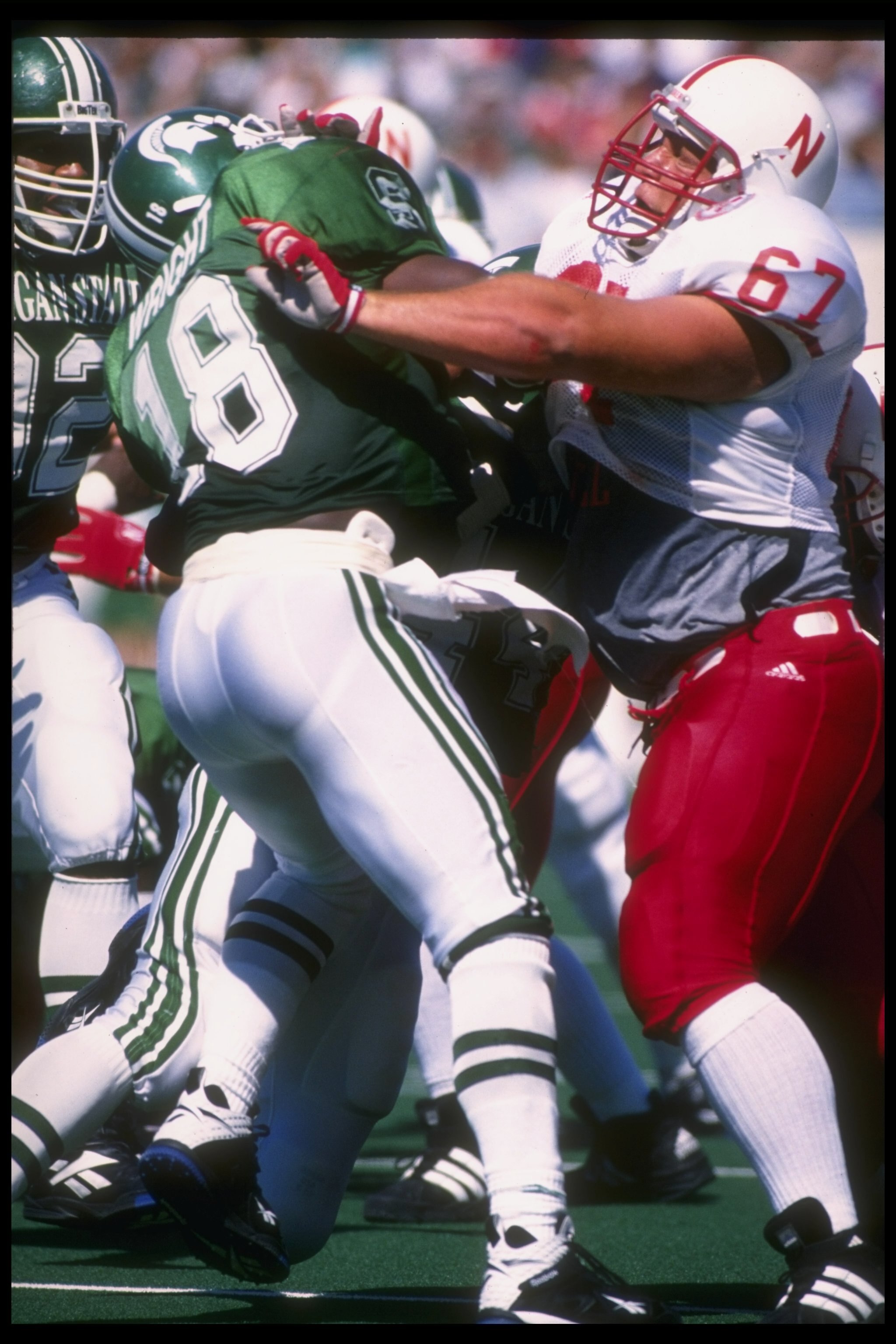 9 Sep 1995:  Center Aaron Taylor of the Nebraska Cornhuskers (right) blocks safety Marvin Wright of the Michigan State Spartans during a game at Spartan Stadium in East Lansing, Michigan.  Nebraska won the game, 50-10. Mandatory Credit: Jonathan Daniel  /