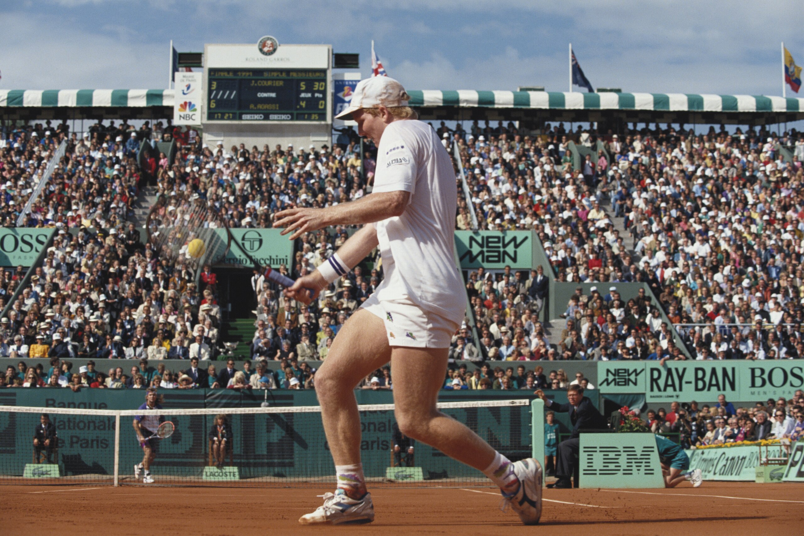 JUN 1991:  JIM COURIER OF THE UNITED STATES PLAYS A BACKHAND RETURN DURING THE MENS SINGLES FINALS AT THE 1991 FRENCH OPEN AT ROLAND GARROS. COURIER DEFEATED ANDRE AGASSI OF THE UNITED STATES TO TAKE THE CHAMPIONSHIP.
